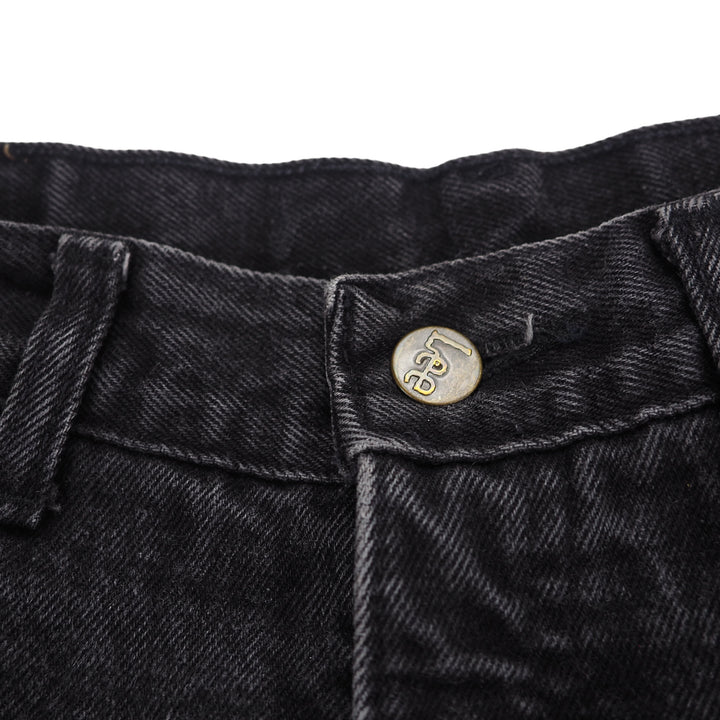 Close-up of black denim jeans with a 'Lee' branded button and stitching detail on a white background