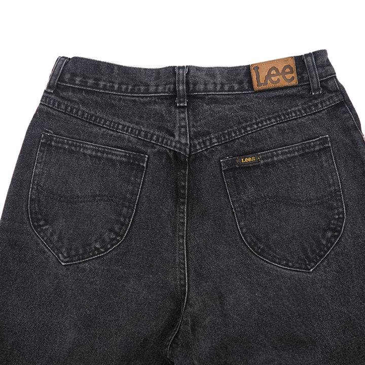 Black jeans with a leather 'Lee' jacron patch on a white background
