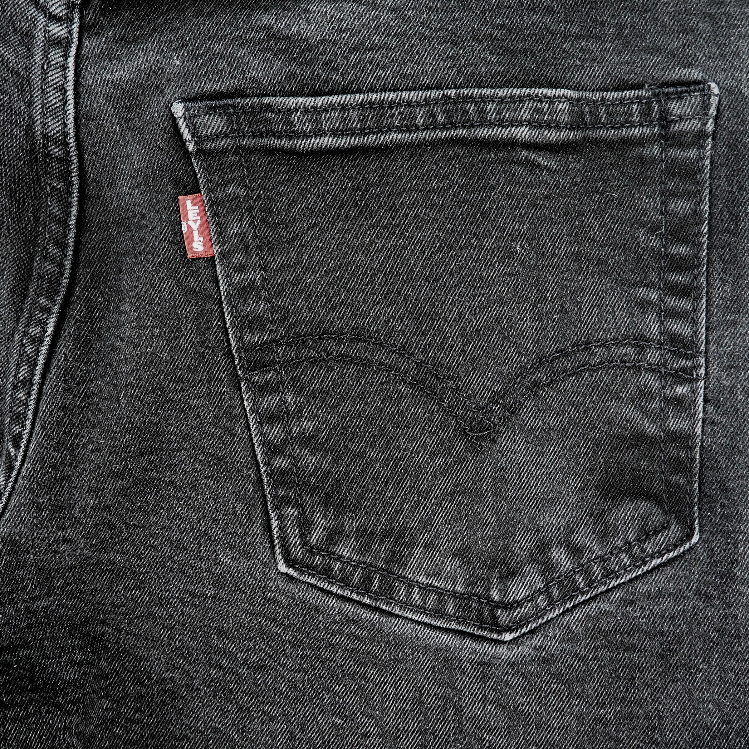 Close-up of a black denim rear pocket with a Levi's Big E red tag logo