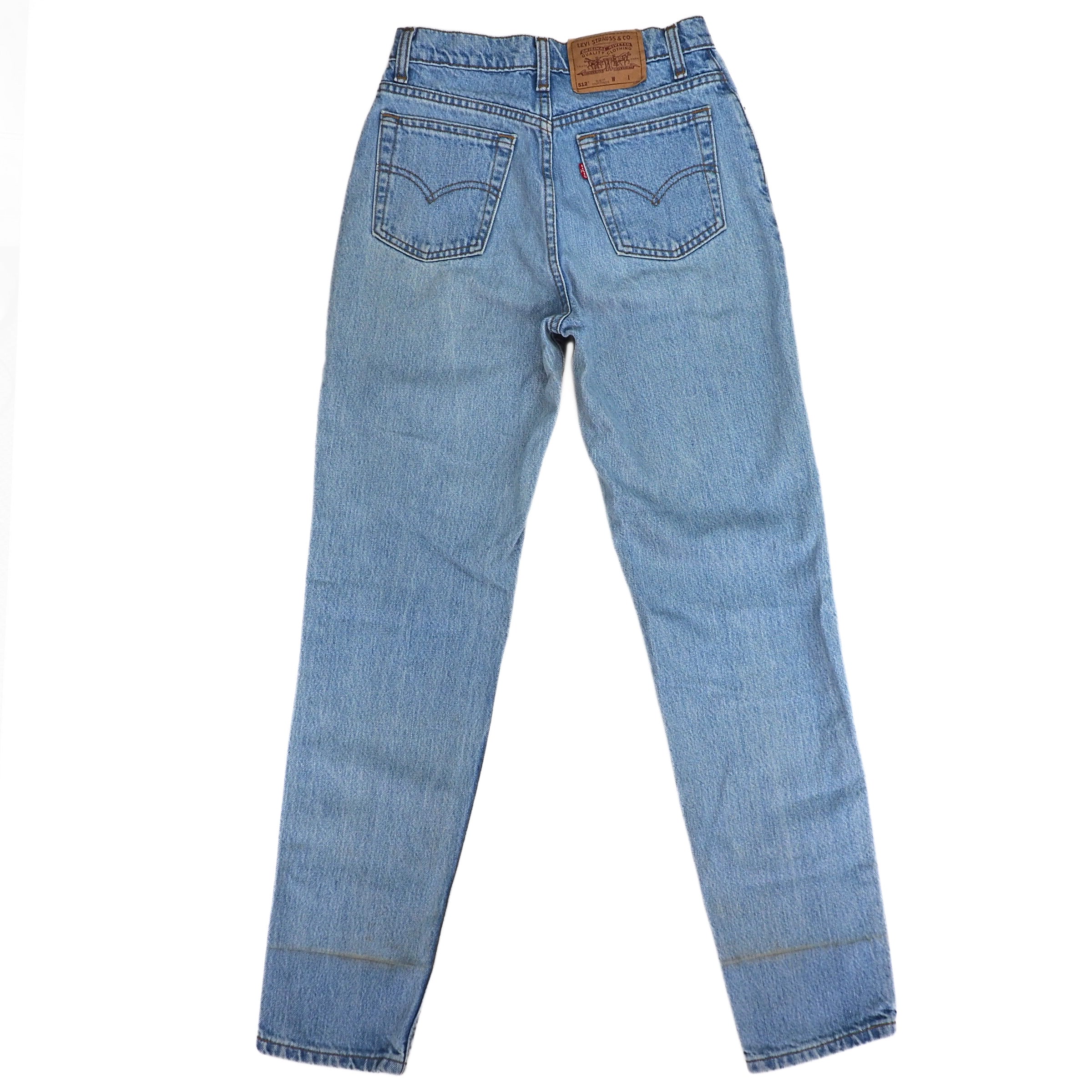 Rear view of a pair of blue denim jeans on a white background
