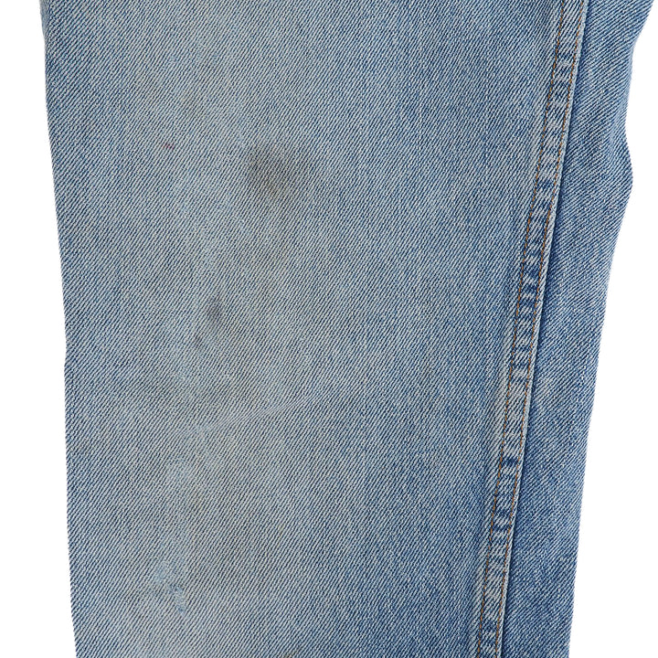 Close-up of light blue denim fabric with a white background