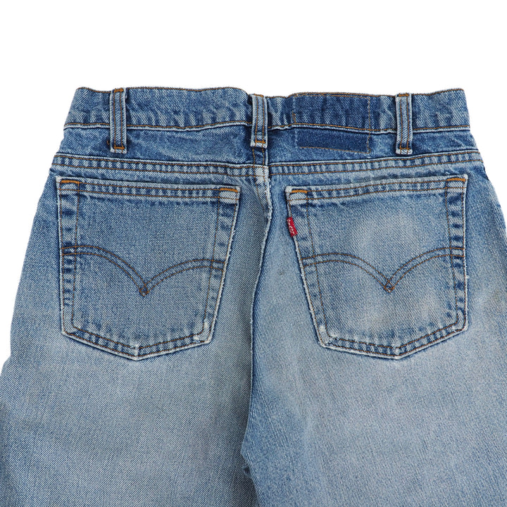 Back view of blue denim levi's jeans with ared tab on a white background