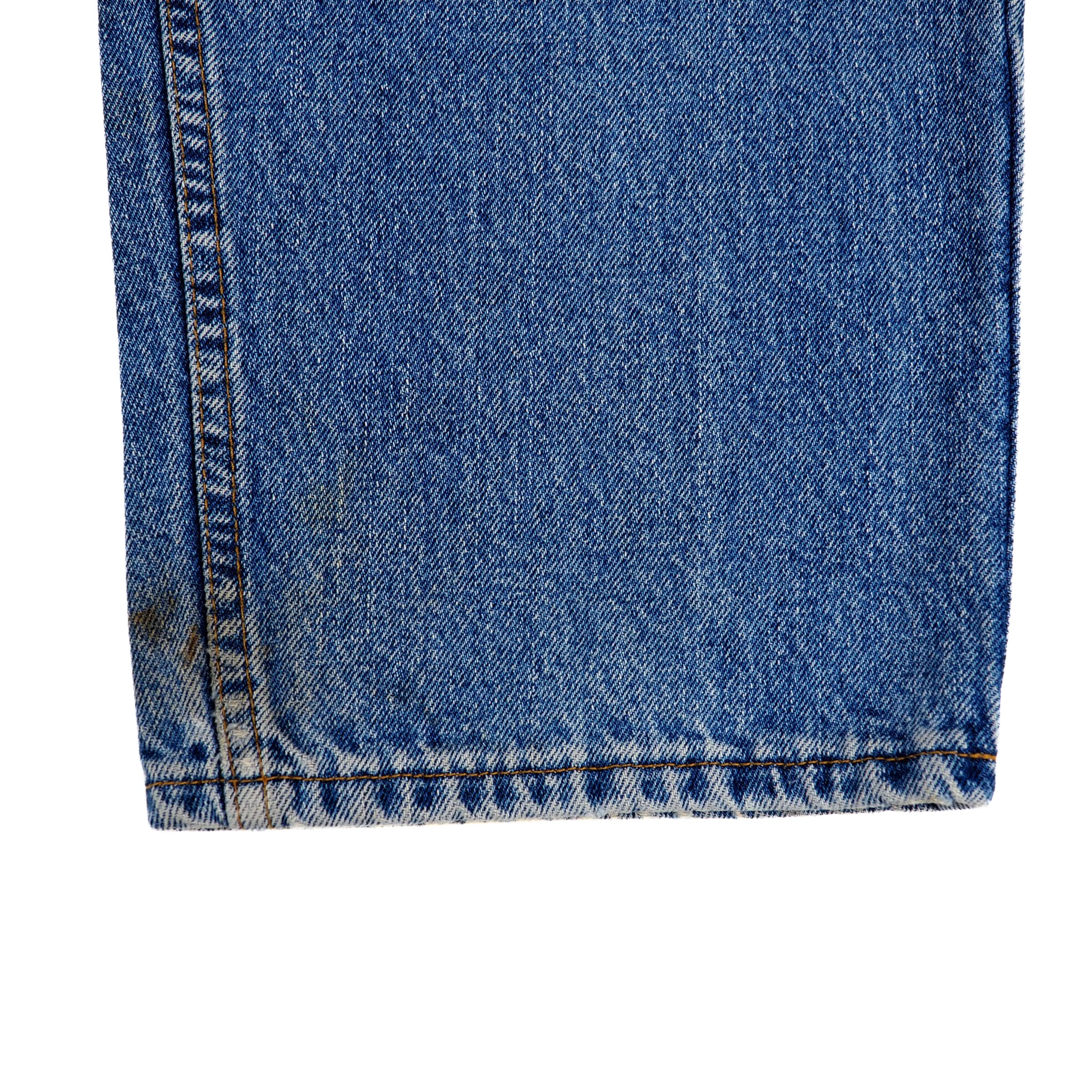 Close-up of blue denim jean ankle cuff on a white background