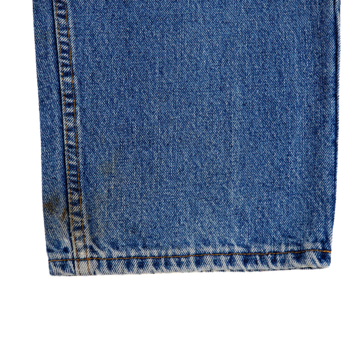 Close-up of blue denim jean ankle cuff on a white background