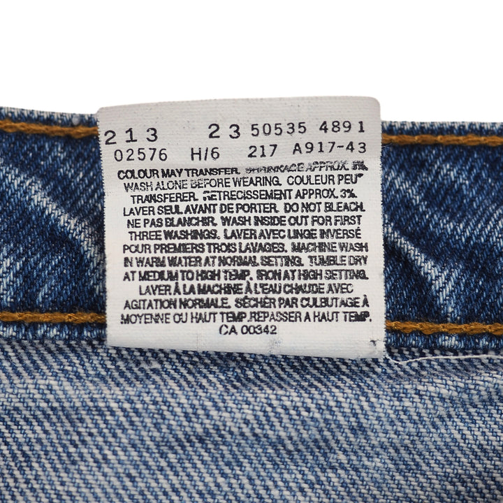 Close-up of a denim fabric with a label on a white background