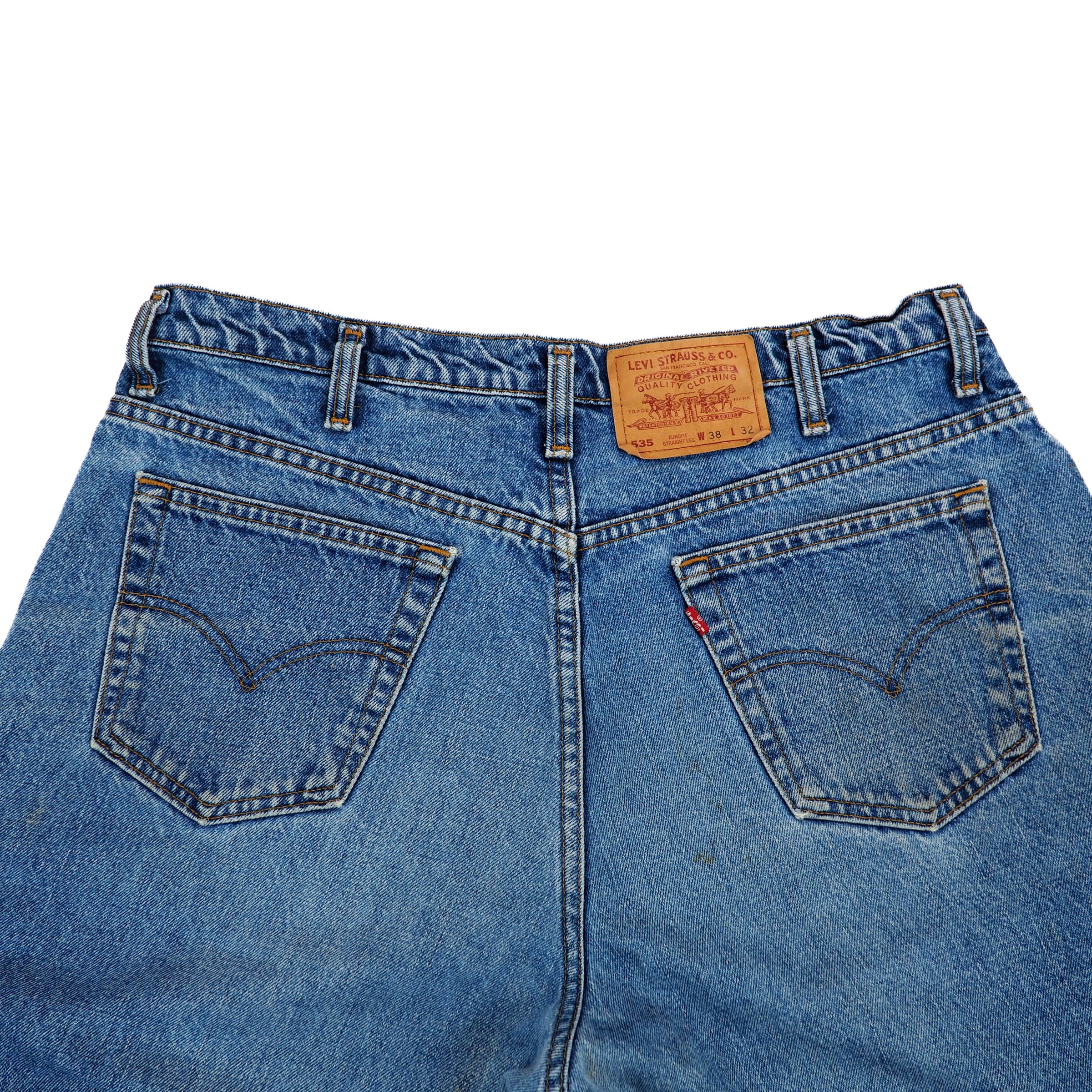 Back view of blue jeans with a Levi's label on a white background