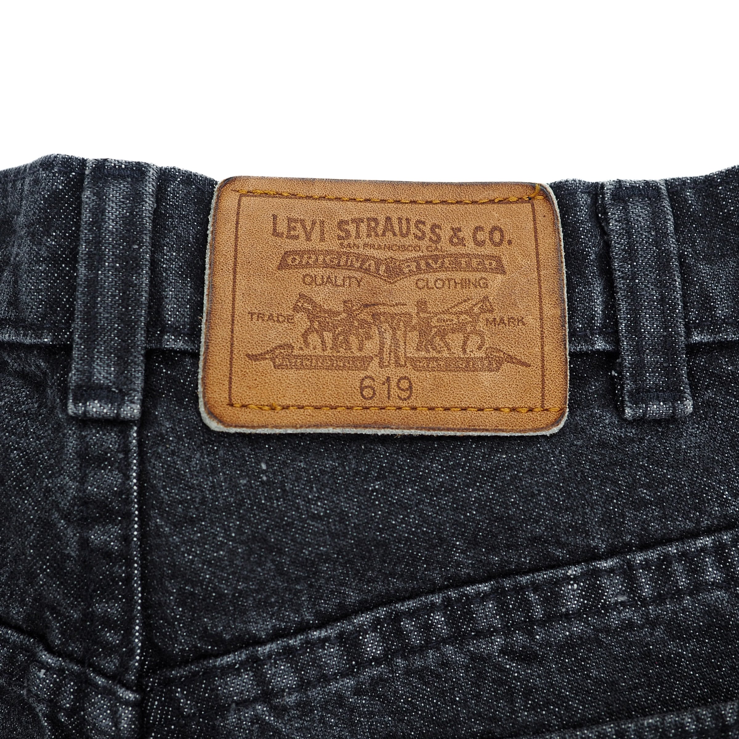 Levi Strauss & Co. leather jacron patch on a pair of black jeans with a white background