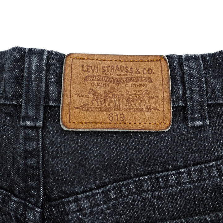 Levi Strauss & Co. leather jacron patch on a pair of black jeans with a white background