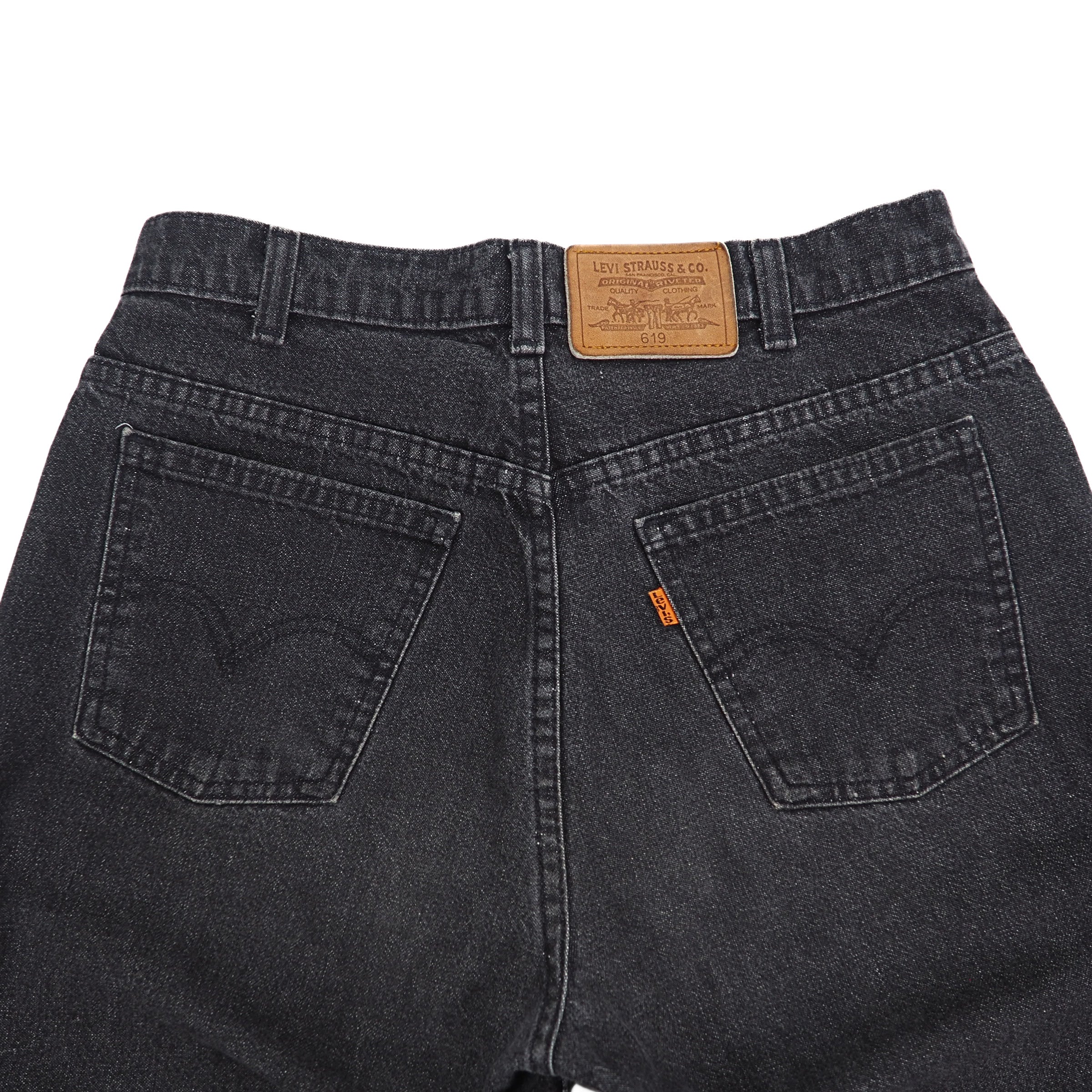 Back view of black Levi's jeans with leather jacron patch and orange lab logo on a white background