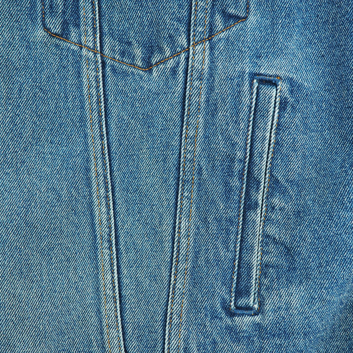 Close-up of a blue denim fabric surface showing a pocket opening, stitched seams, and the woven texture of the material.