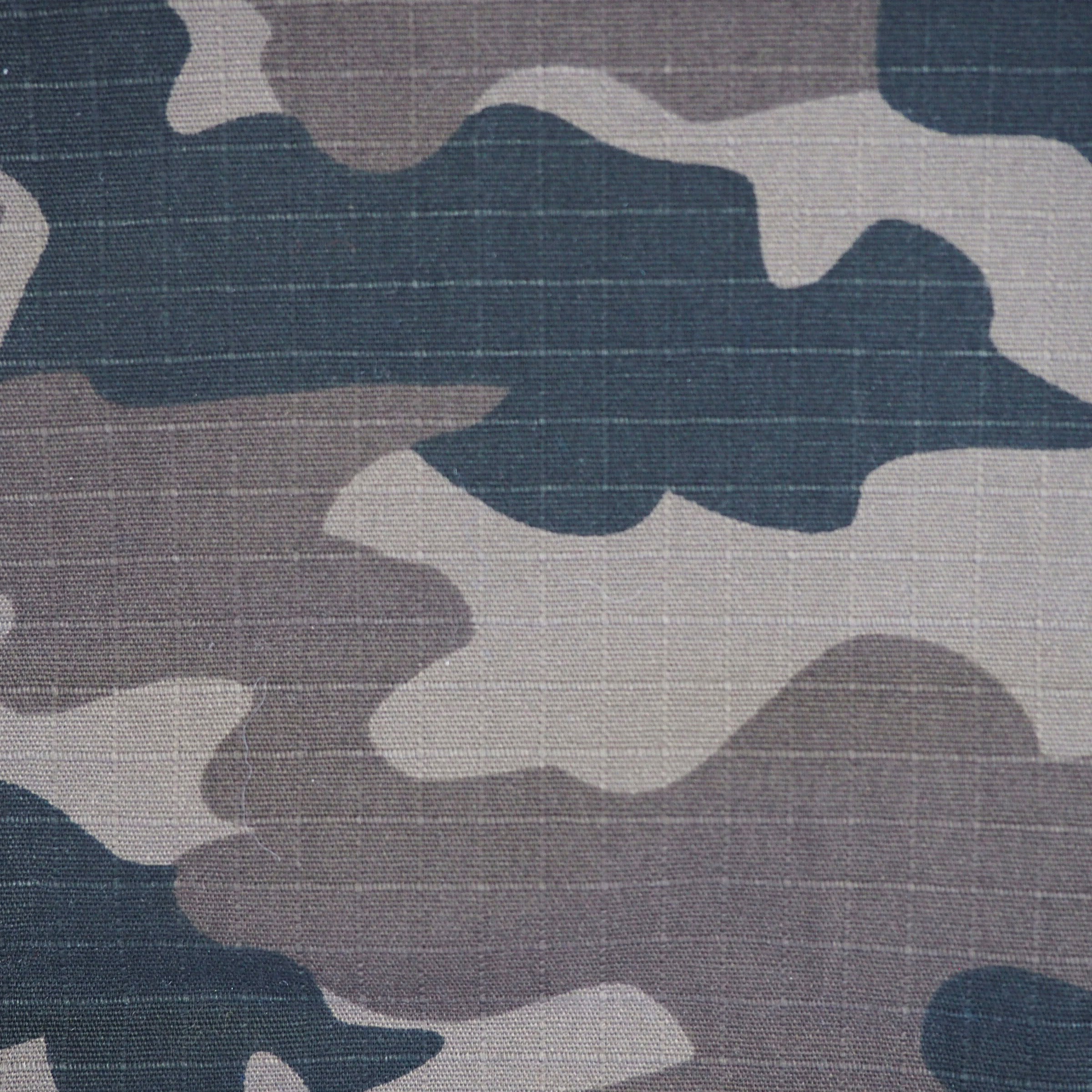 Camouflage pattern in black, beige and brown on ripstop fabric texture
