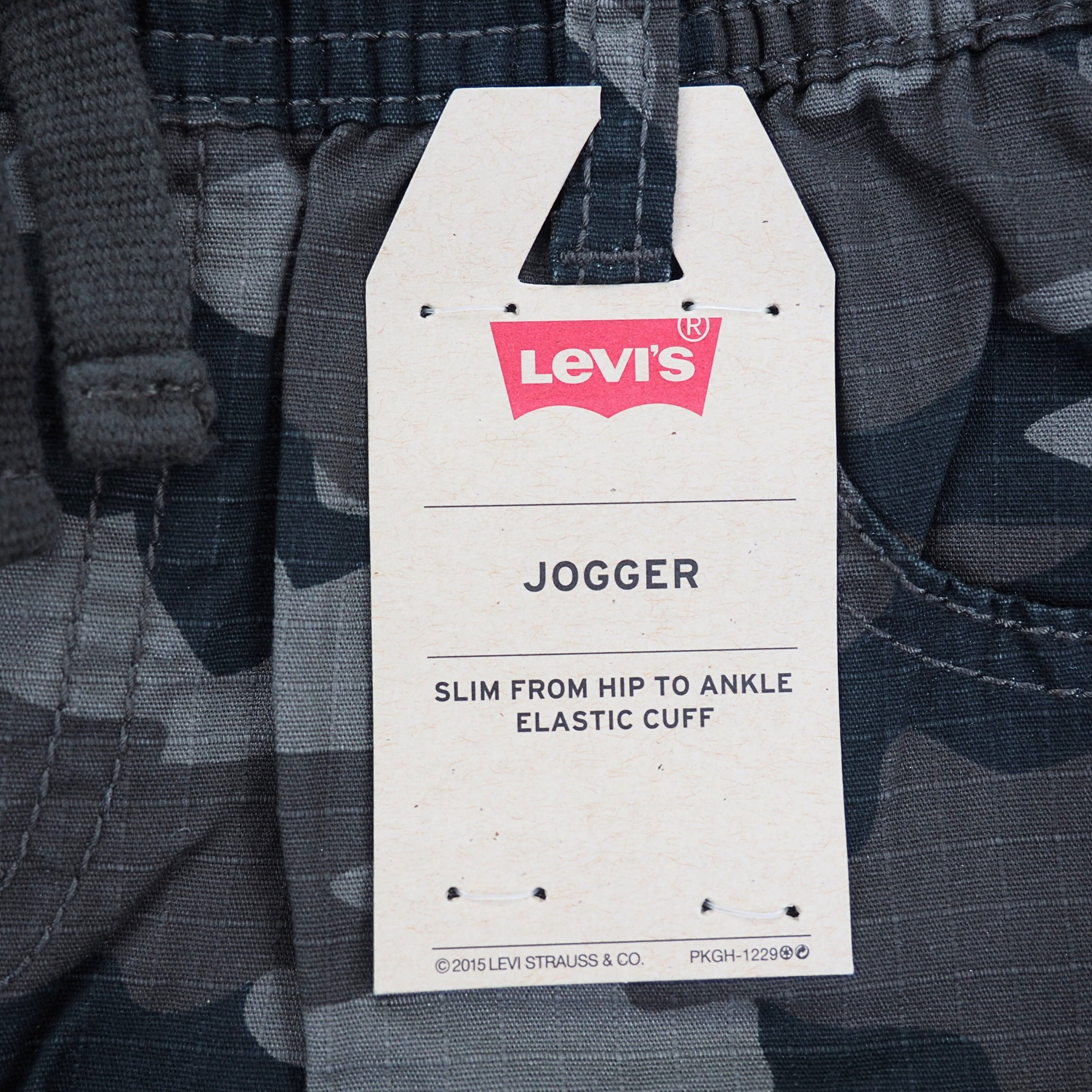 Levi's jogger pants with a tag on a camouflage background