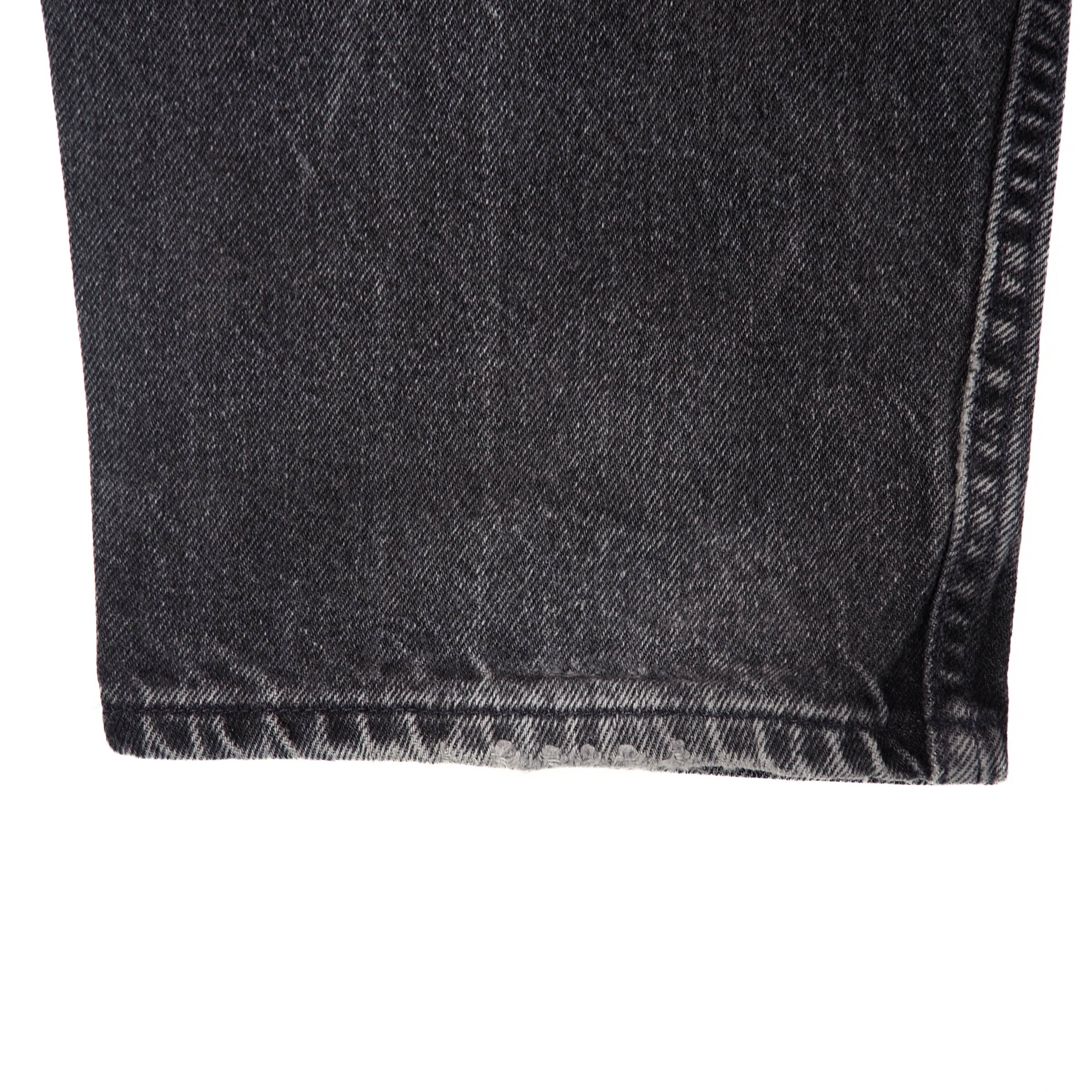 Close-up of dark gray denim fabric on a white background
