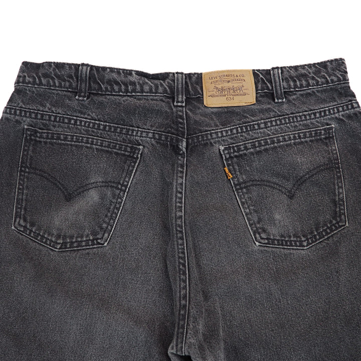 Black jeans with a Levi's label on a white background
