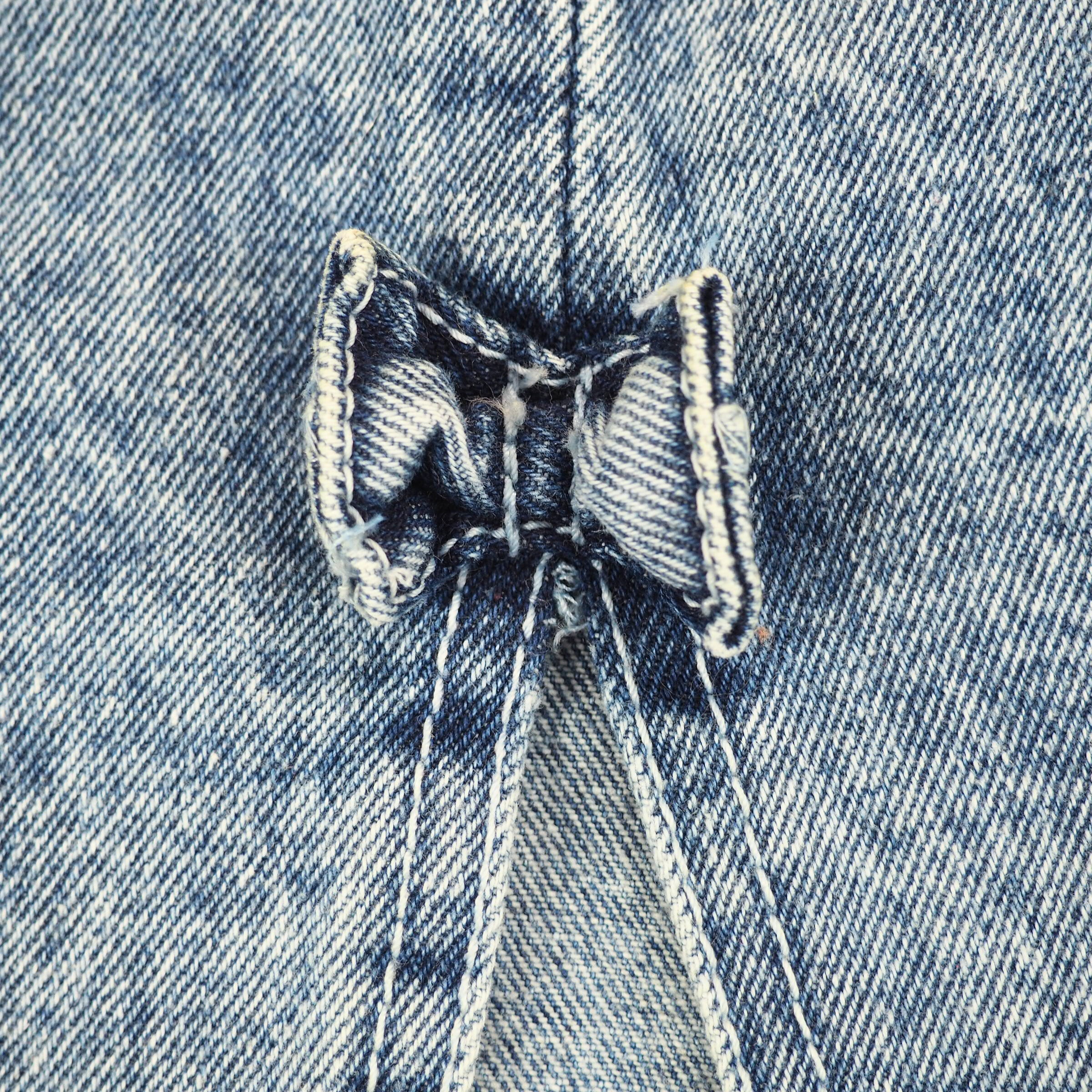 Close up of a denim bow tie on a denim skirt.