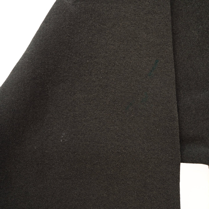 Close-up of a black gsweater sleeve on a white background