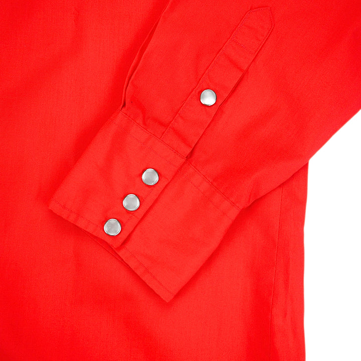 Close up of pearl snap buttons of the cuff of a red dress shirt.
