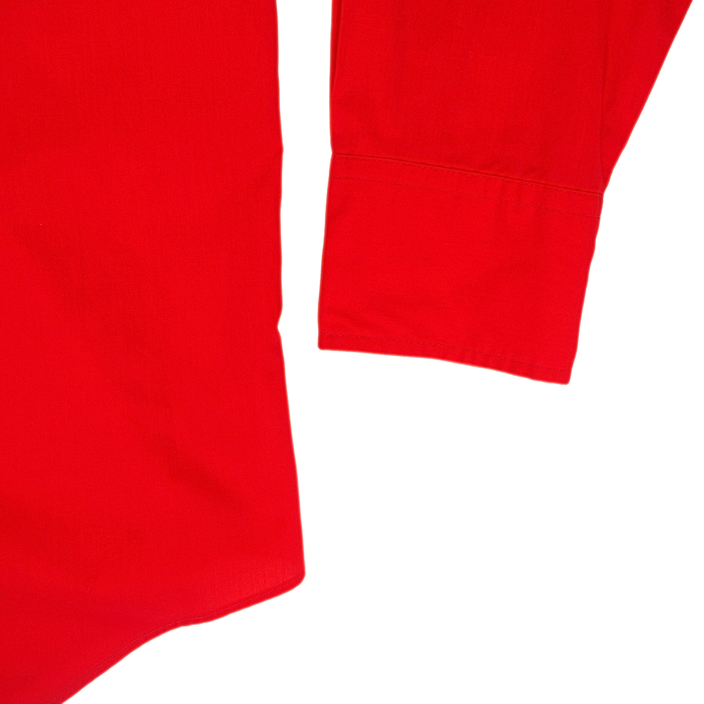 Close up of the sleeve cuff of a red shirt.