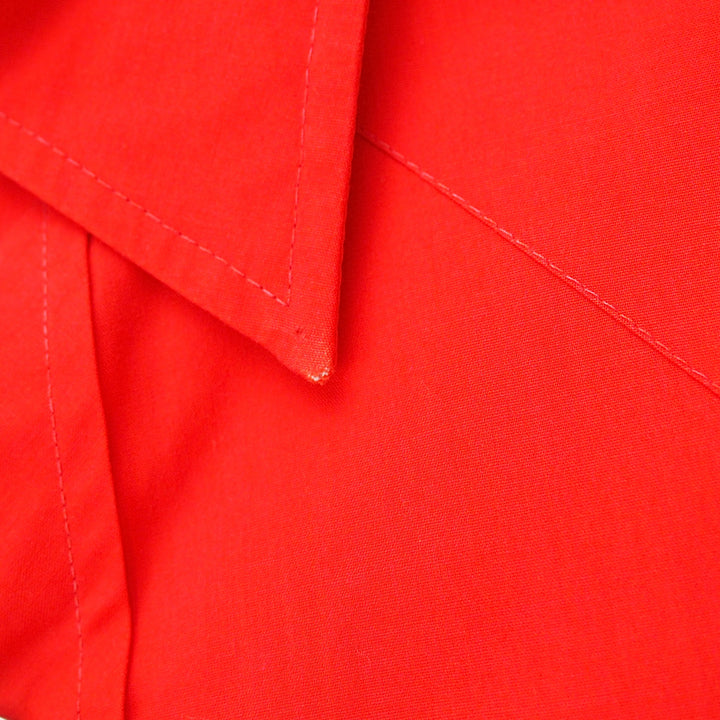 Close up of the collar of a red dress shirt.