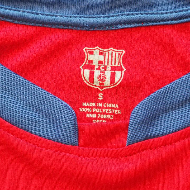 Close-up of the inside collar of a red sports jersey with blue accents and a visible FCB brand logo.