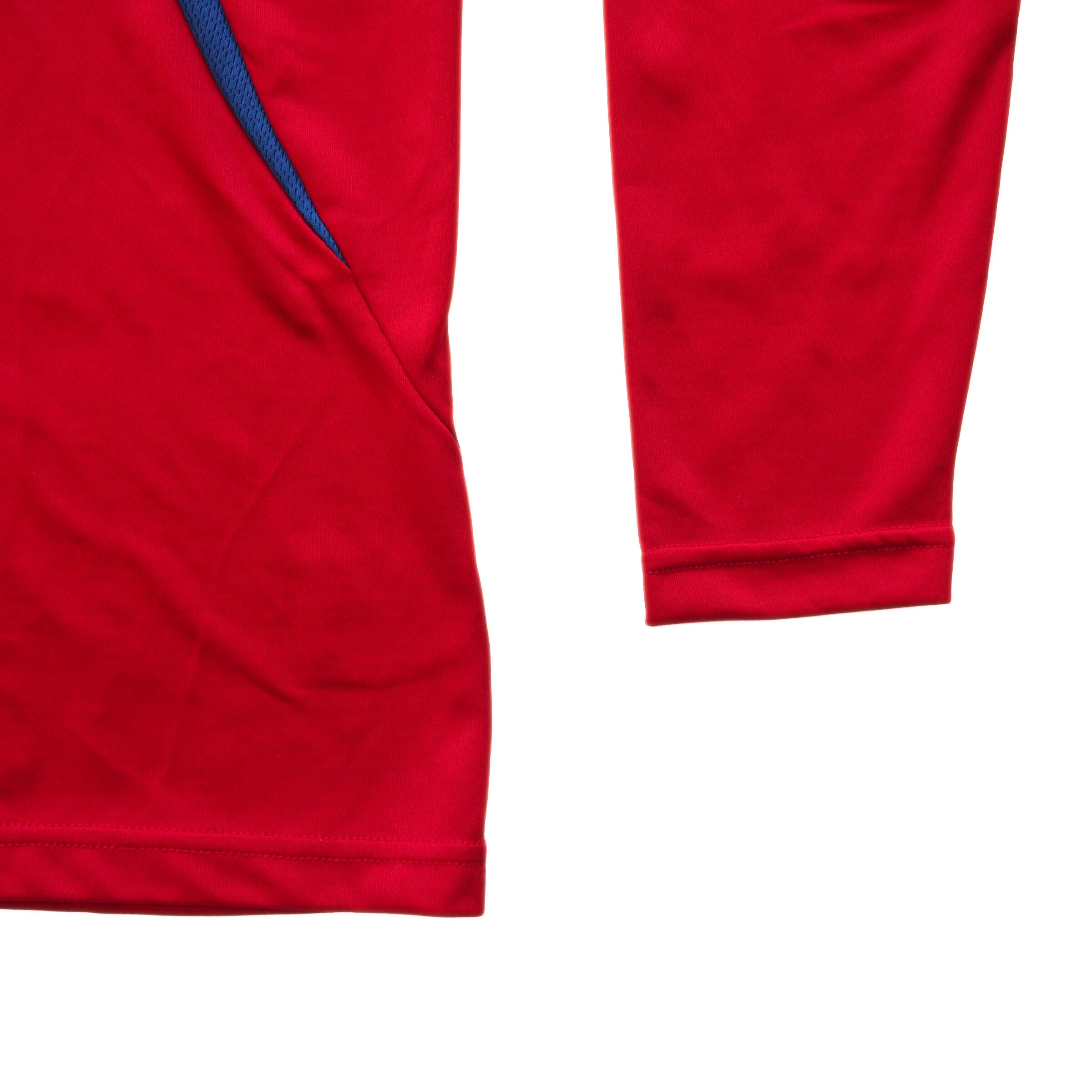 Detail of a red soccer jersey sleeve and cuff on a white background