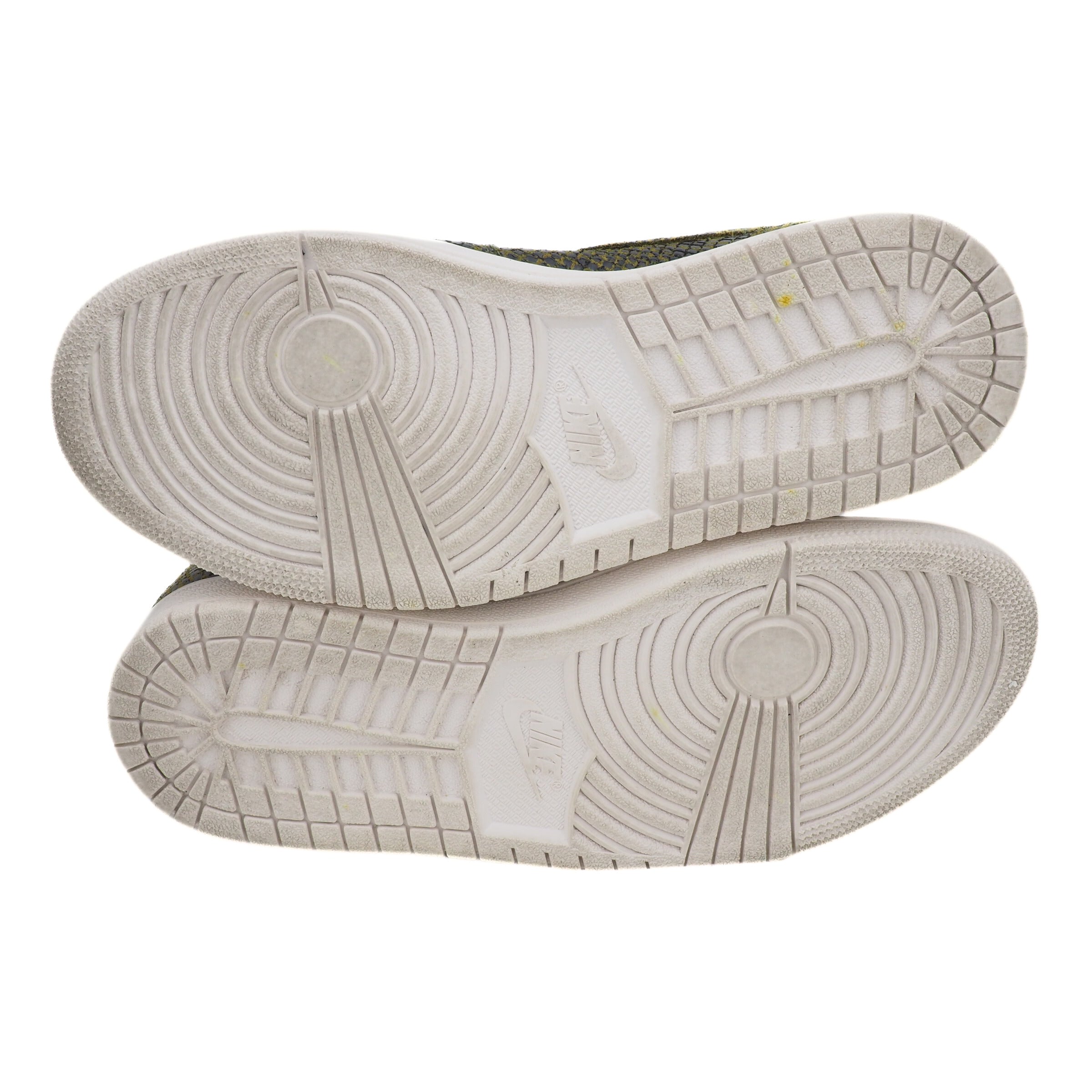 Close-up of white basketball shoe soles with tread pattern and Nike branding on a white background
