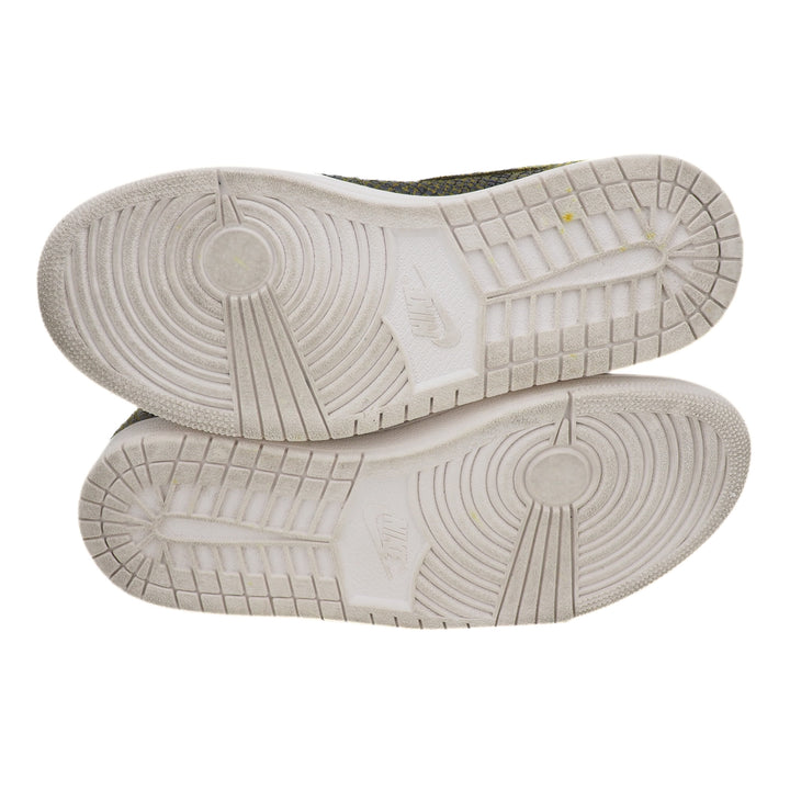 Close-up of white basketball shoe soles with tread pattern and Nike branding on a white background