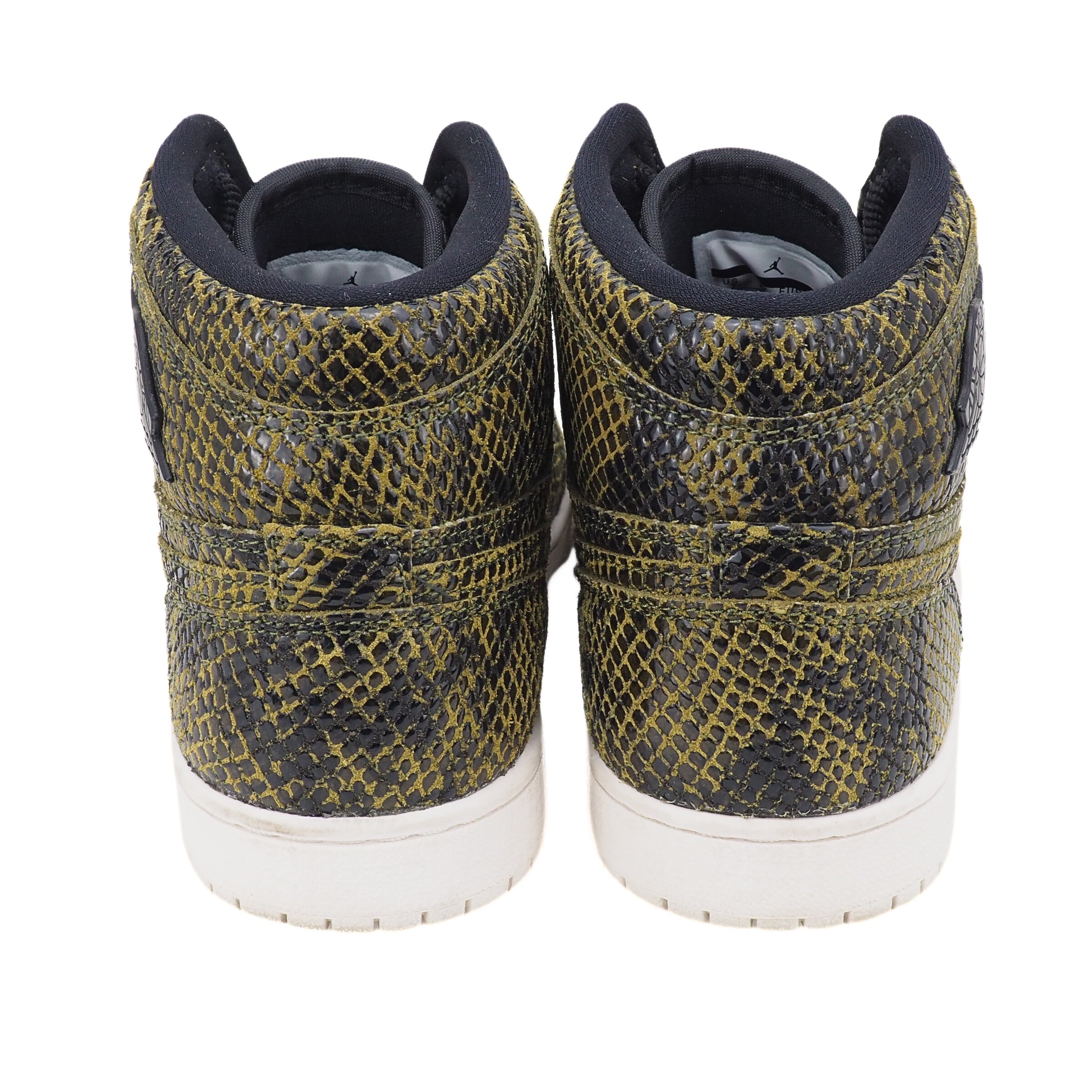 Pair of high-top sneakers with snake print on a white background