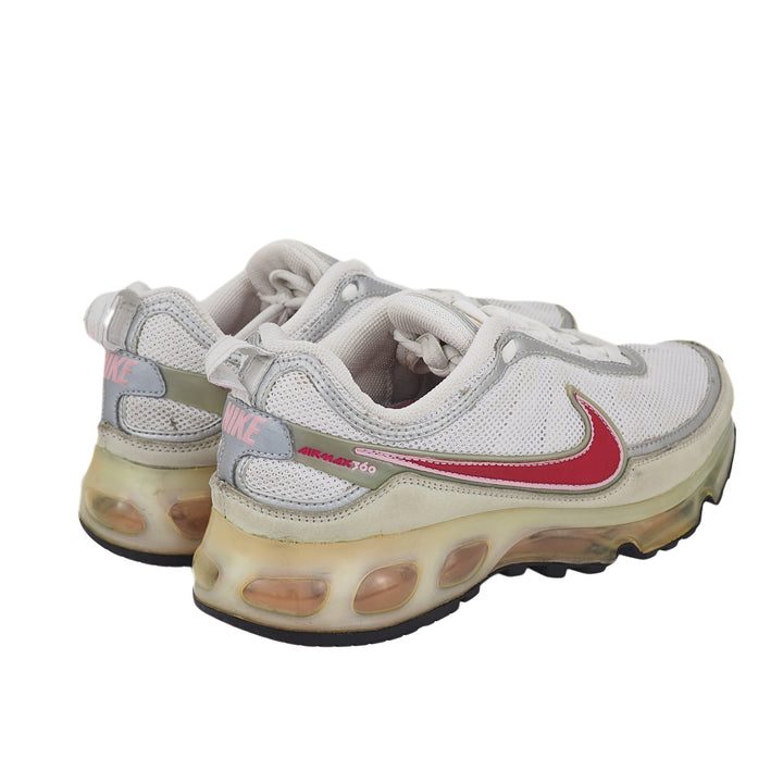 Pair of white Nike running shoes with a red swoosh logo on a white background
