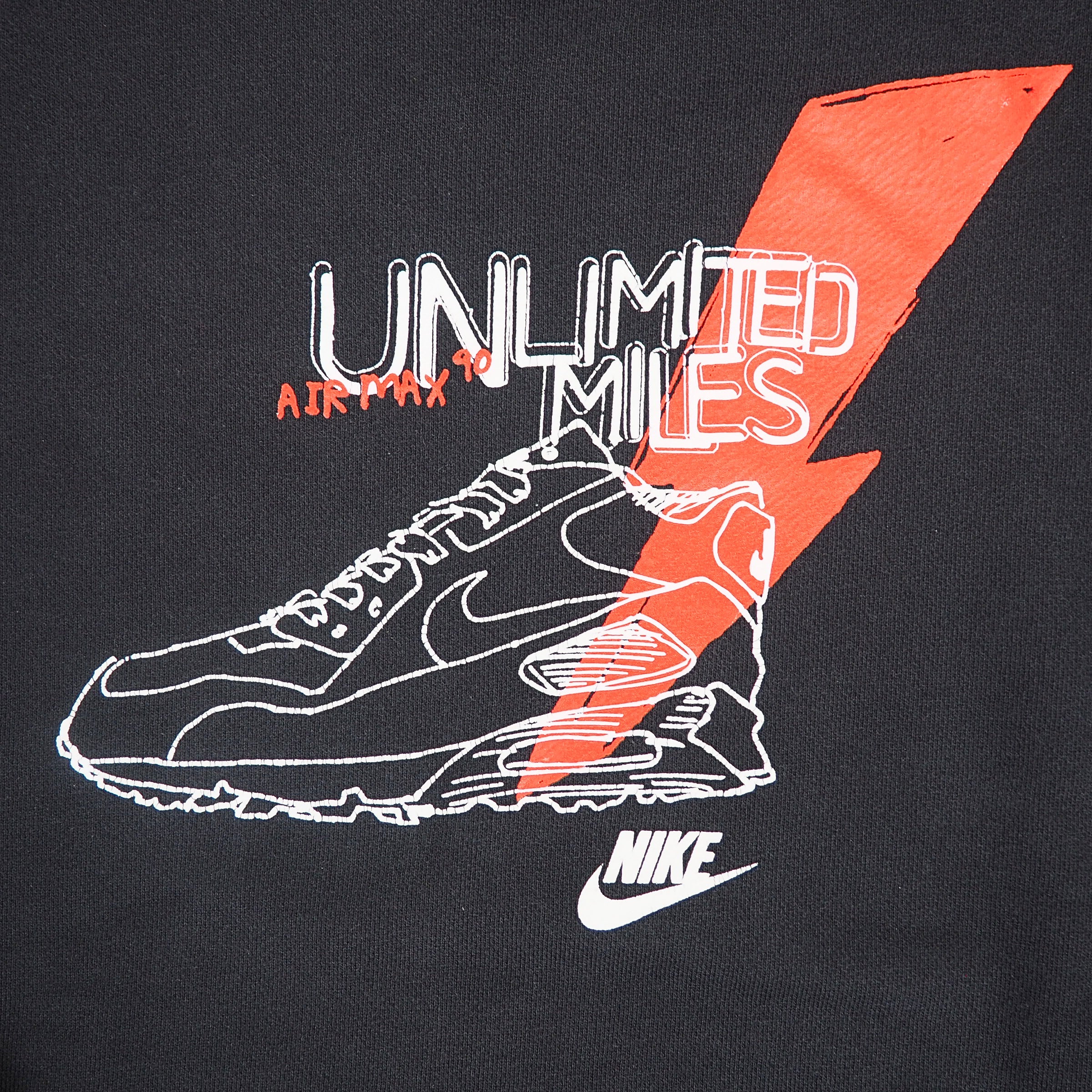 Close up of the graphic logo on a black sweatshirt reading 'Nike Unlimited Miles'