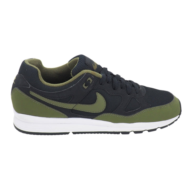 Green and black sneaker with Nike logo on a white background