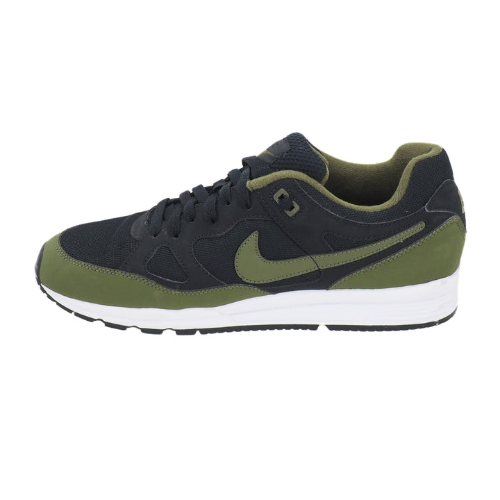 Black and green sneaker with Nike logo on a white background