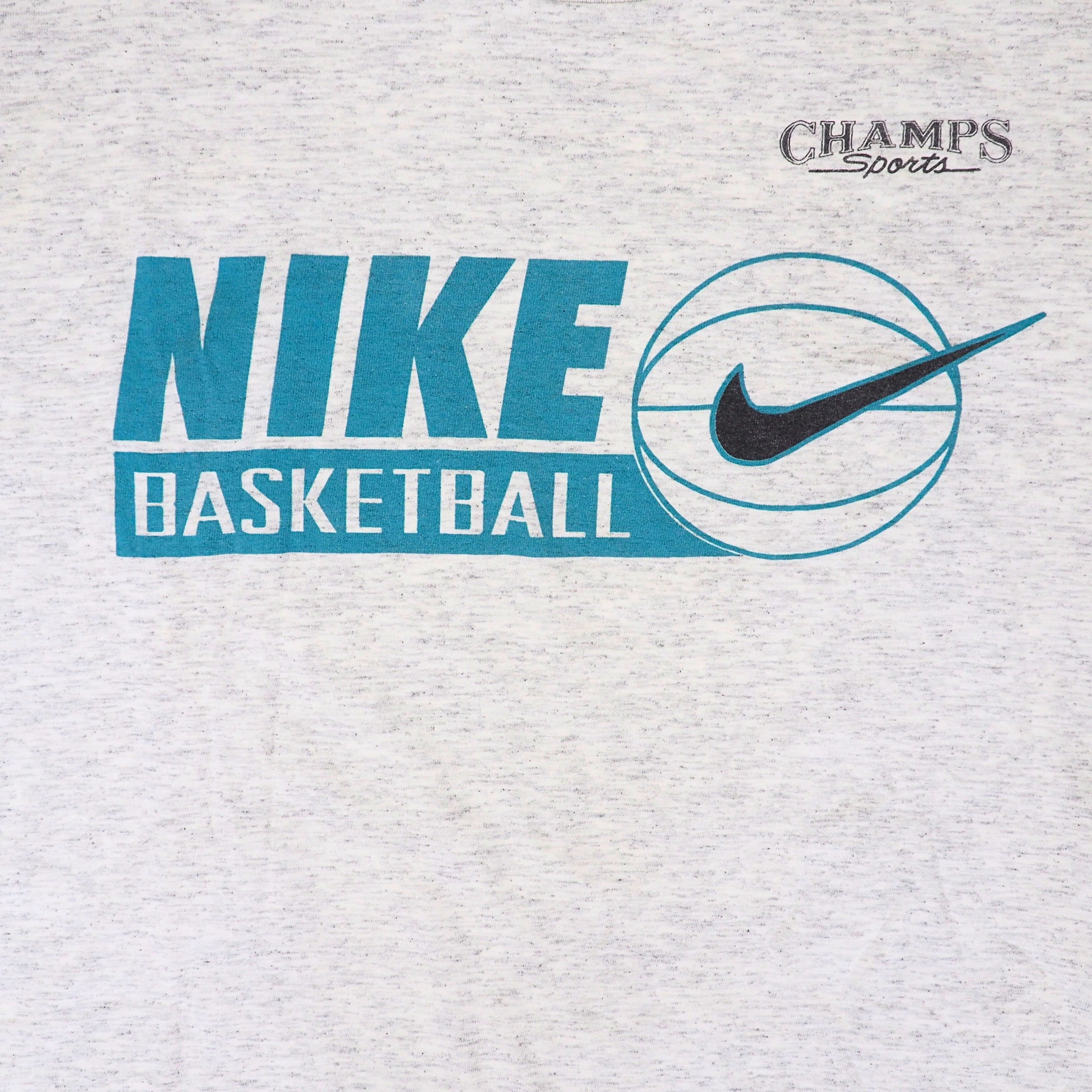 Close up of a t-shirt graphic reading 'Champs Sports' and 'Nike Basketball'