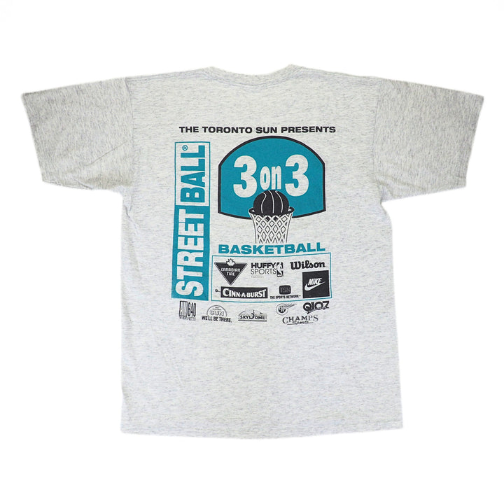 Back view of a grey t-shirt with a graphic print containing multiple brand sponsor logos in teal and black