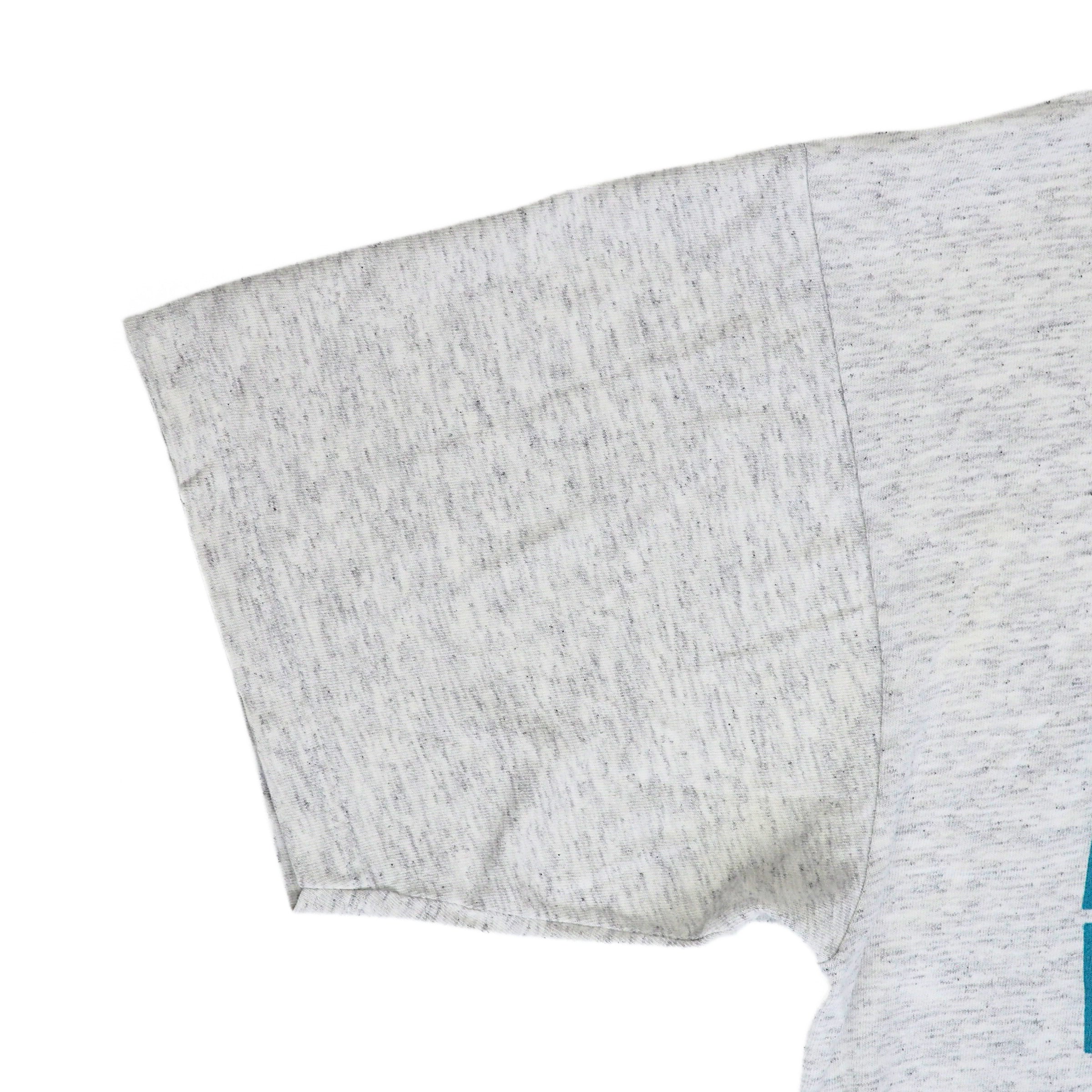 Close up of a grey t-shirt sleeve on a white background