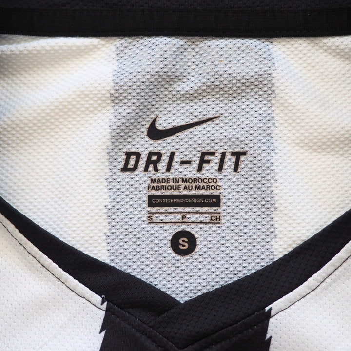 Close-up of a Dri-Fit label on a sports jersey with Nike branding.