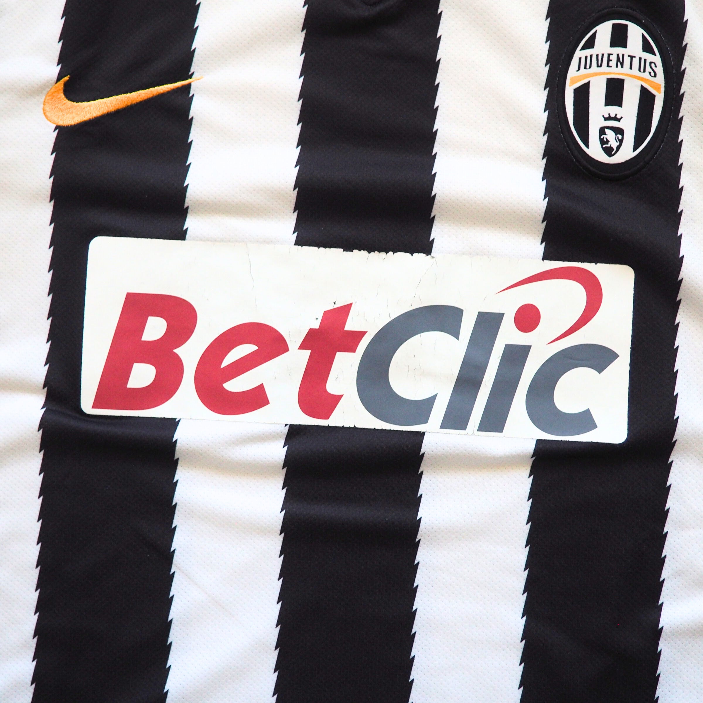 Black and white striped Juventus soccer jersey with Nike Swoosh, Betclic logo and Juventus badge.