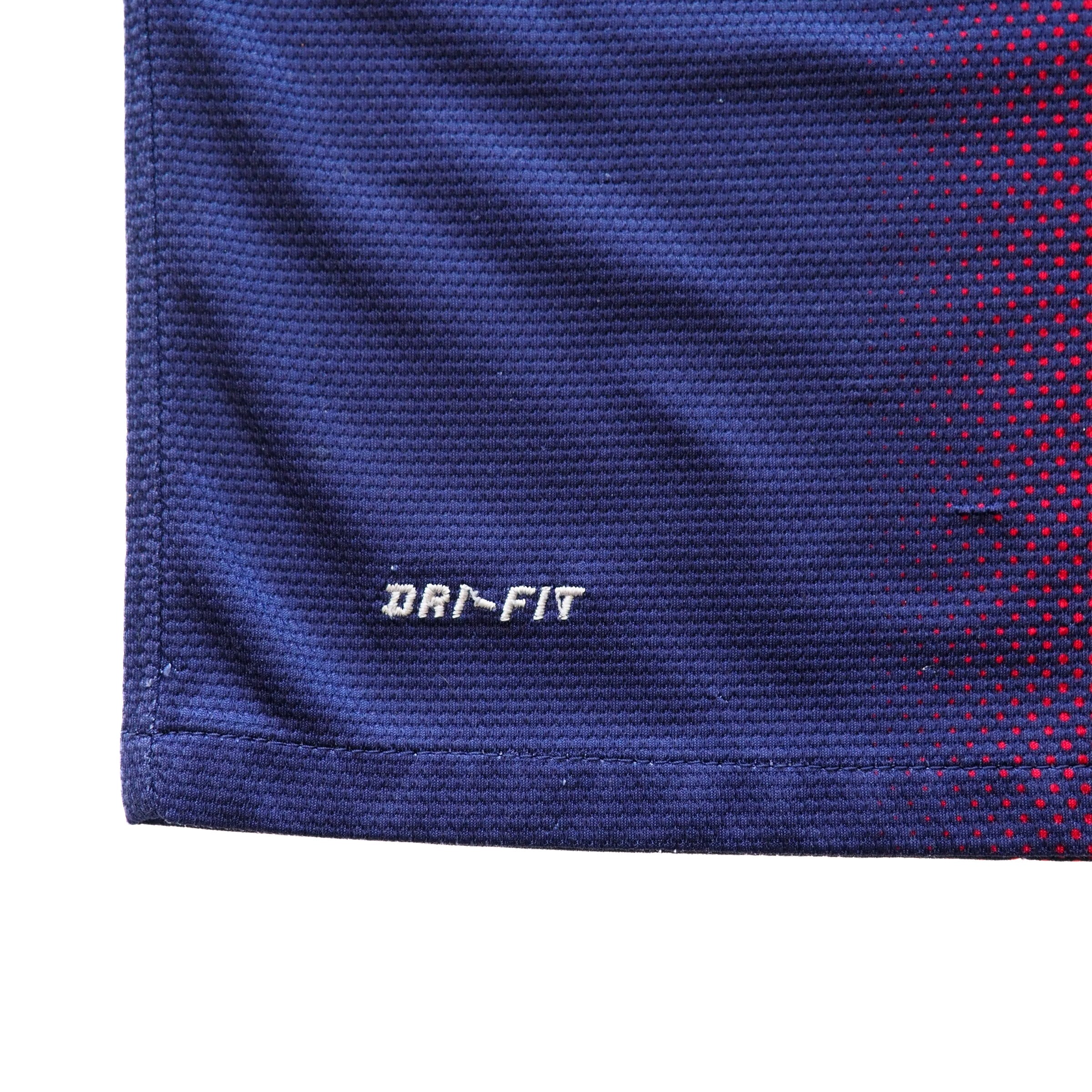 Close-up of blue fabric with Dri-Fit logo on a white background
