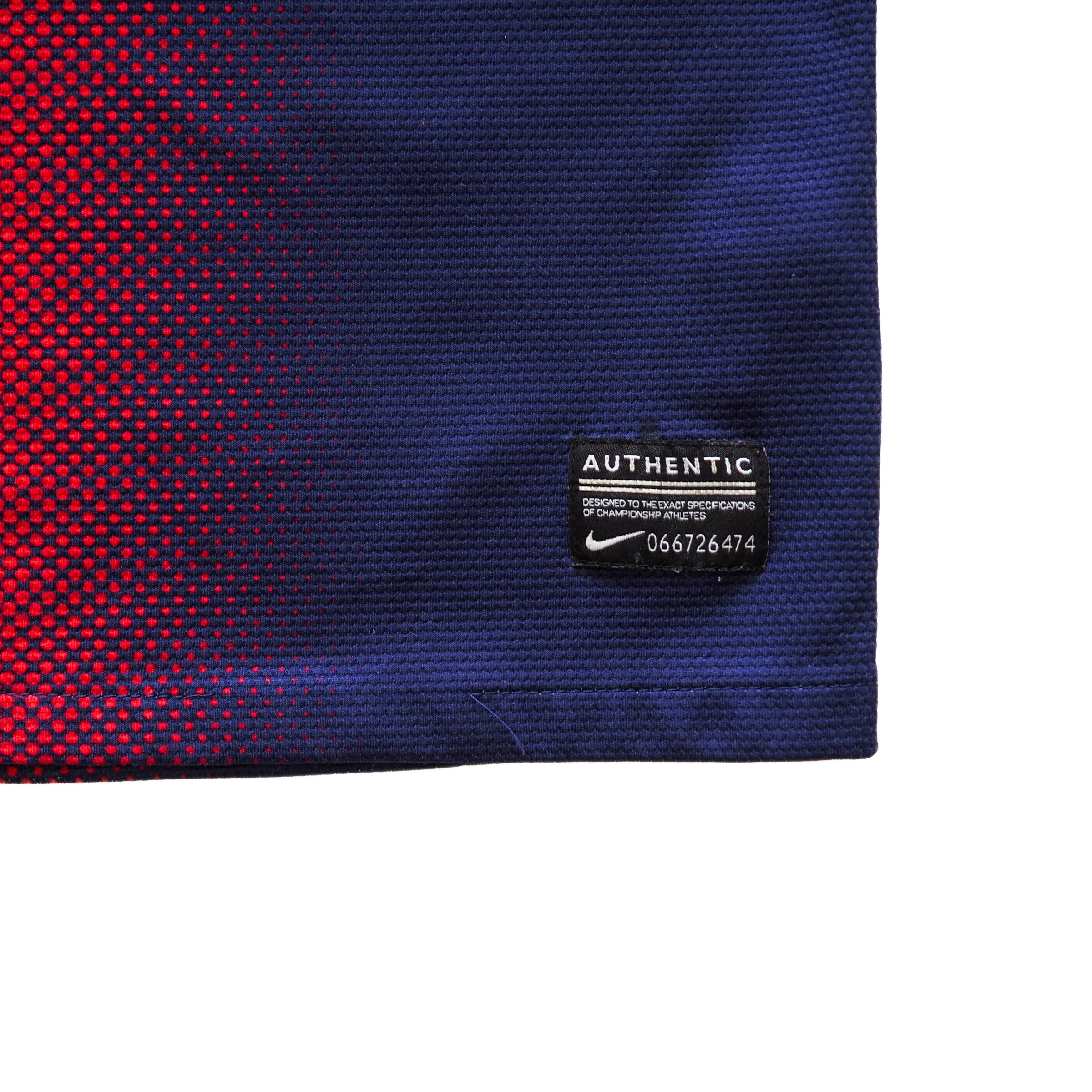 Close-up of a blue and red textured fabric with a numbered 'Authentic Nike' label.