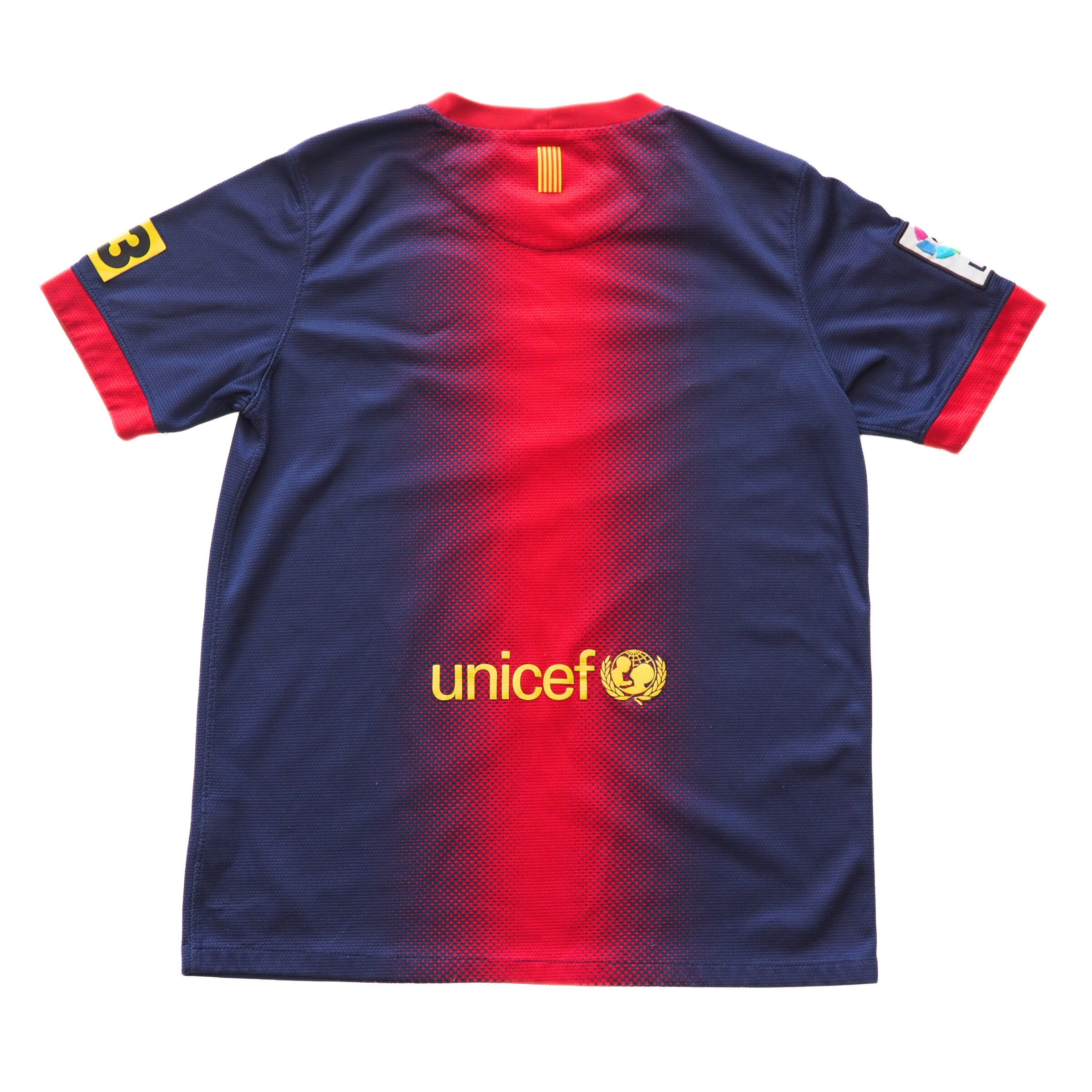 Back view of a navy and red FC Barca soccer jersey with Unicef logo on a white background