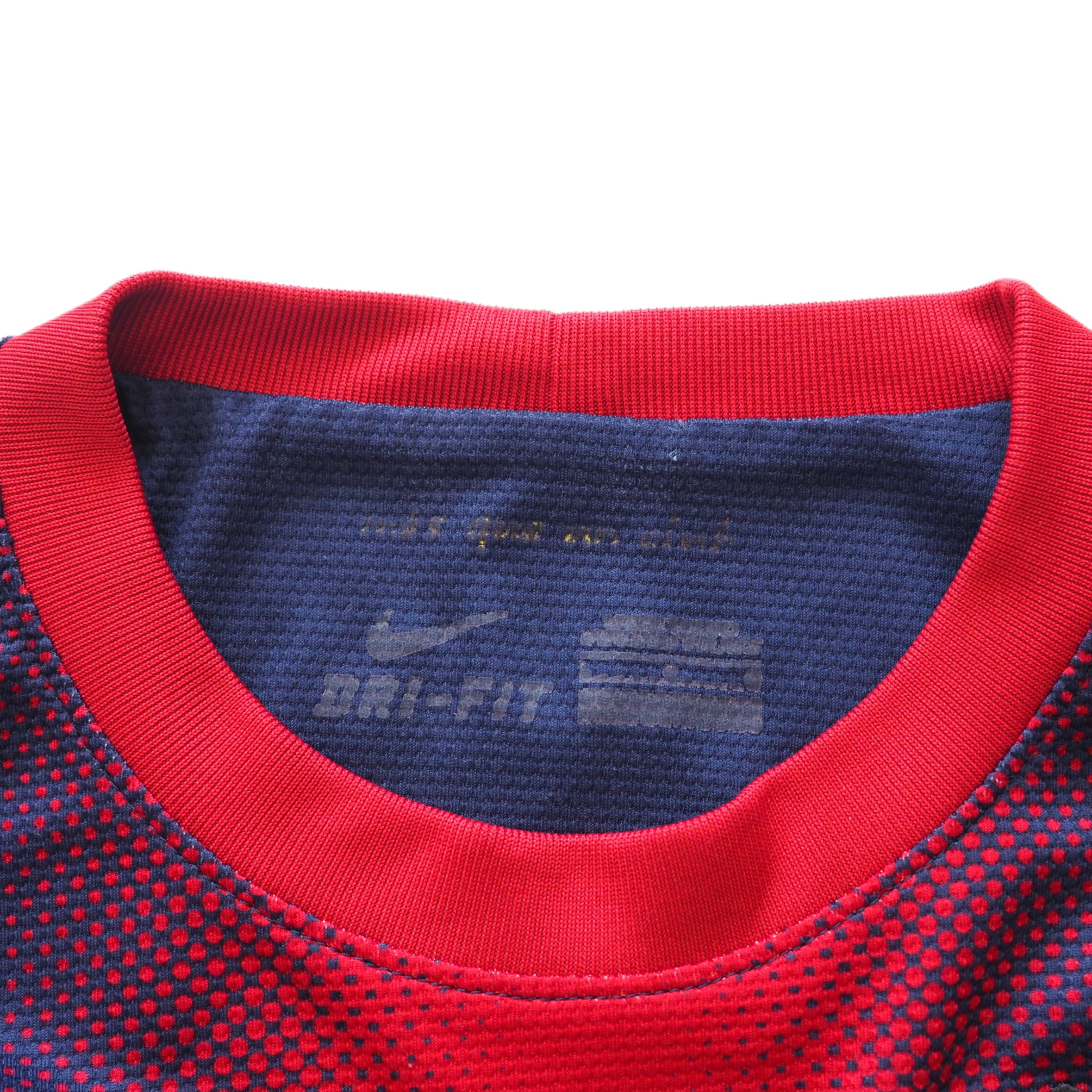 Close-up detail of a red and blue sports shirt collar with Nike Dri-FIT label.