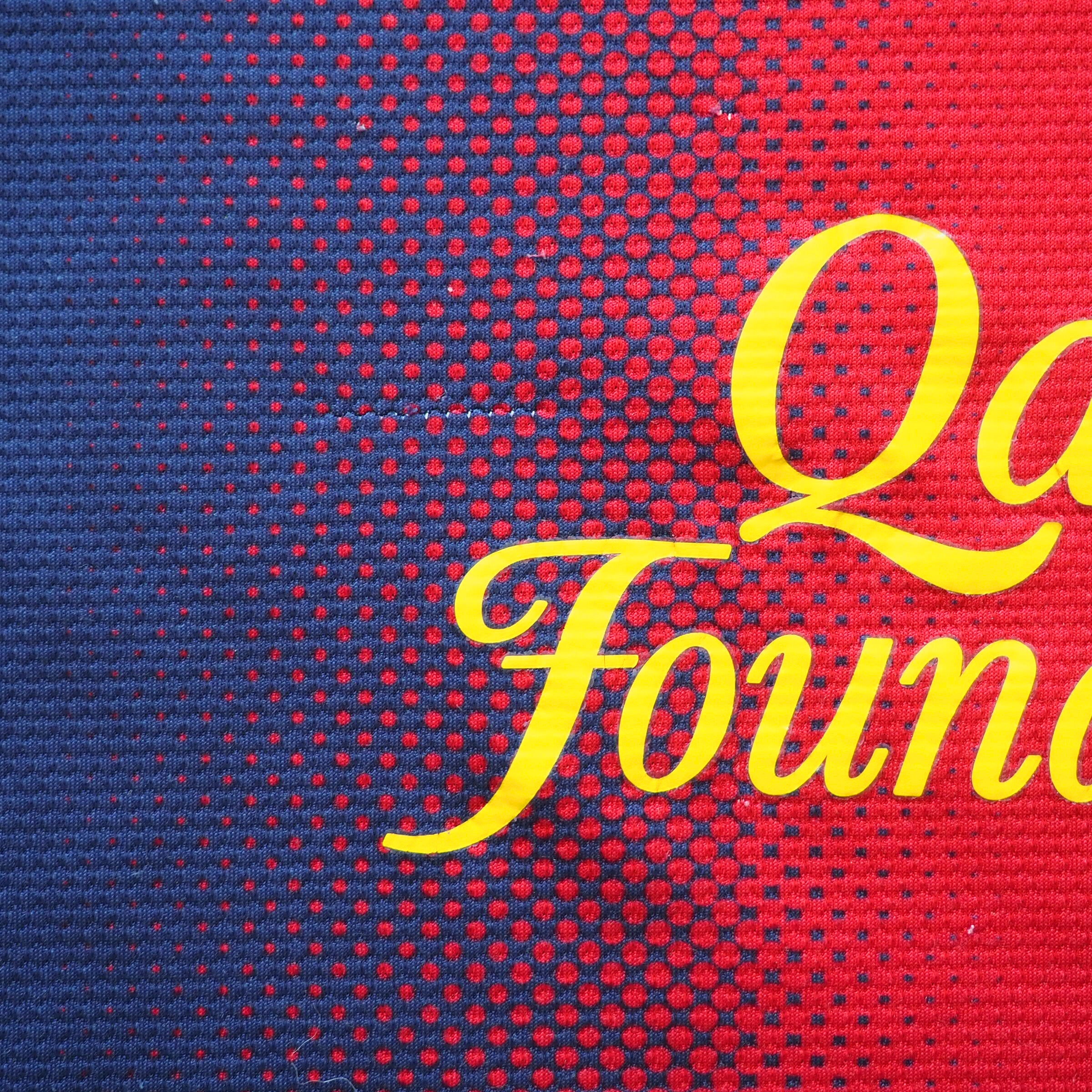 Red and blue patterned fabric with yellow lettering