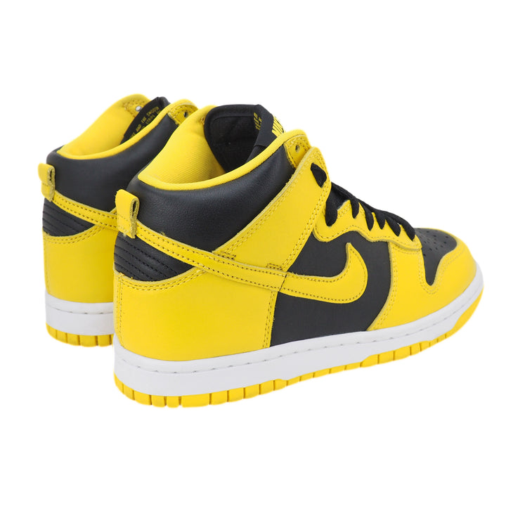Yellow and black Nike Dunk high-top sneakers with a white sole on a white background