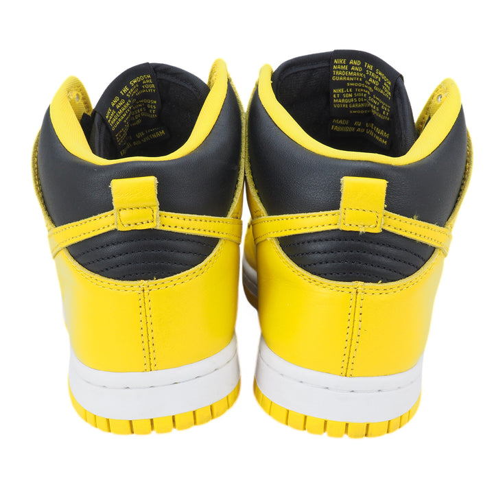 Yellow and black Nike high-top sneakers with white soles on a white background