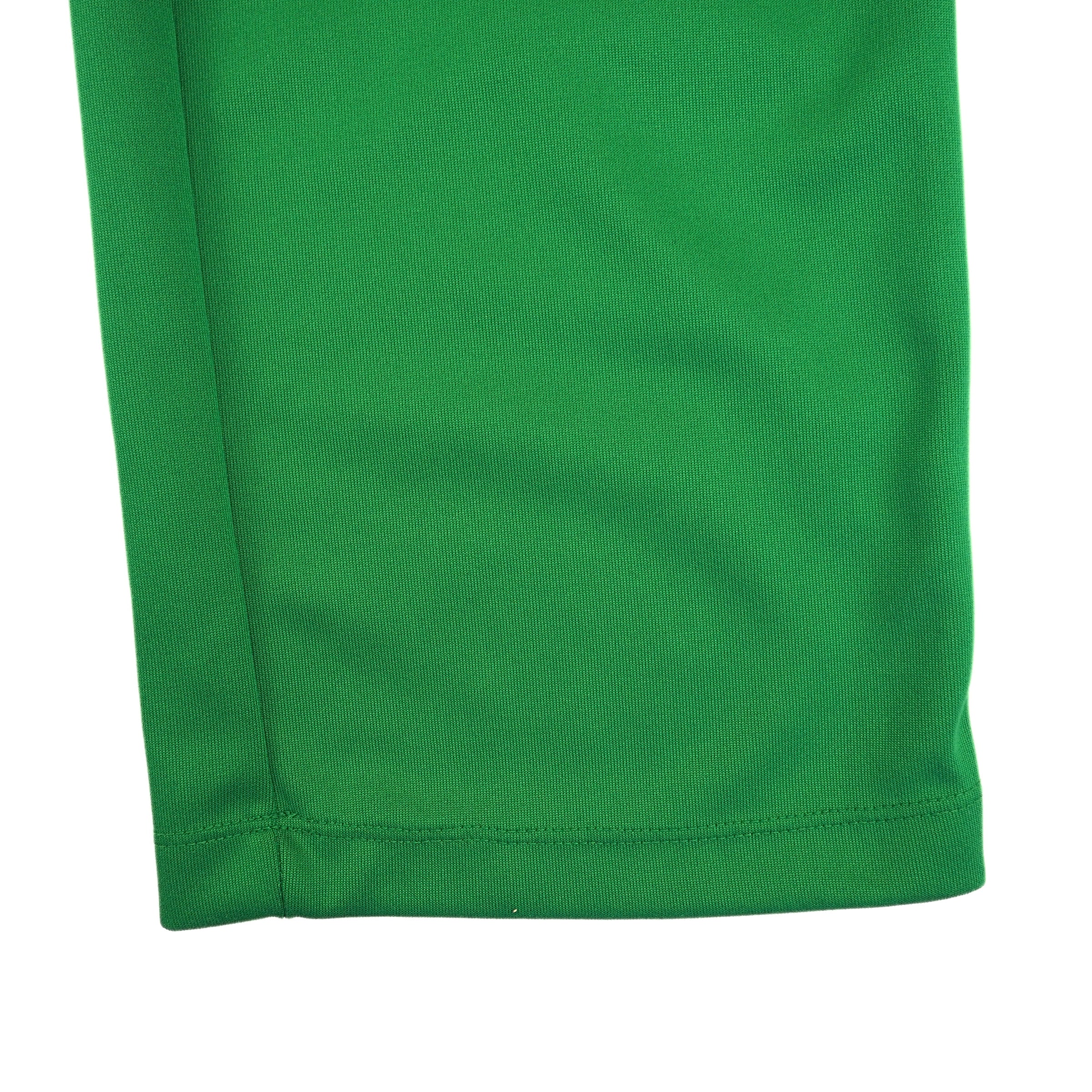 Close-up of green pant leg on a white background