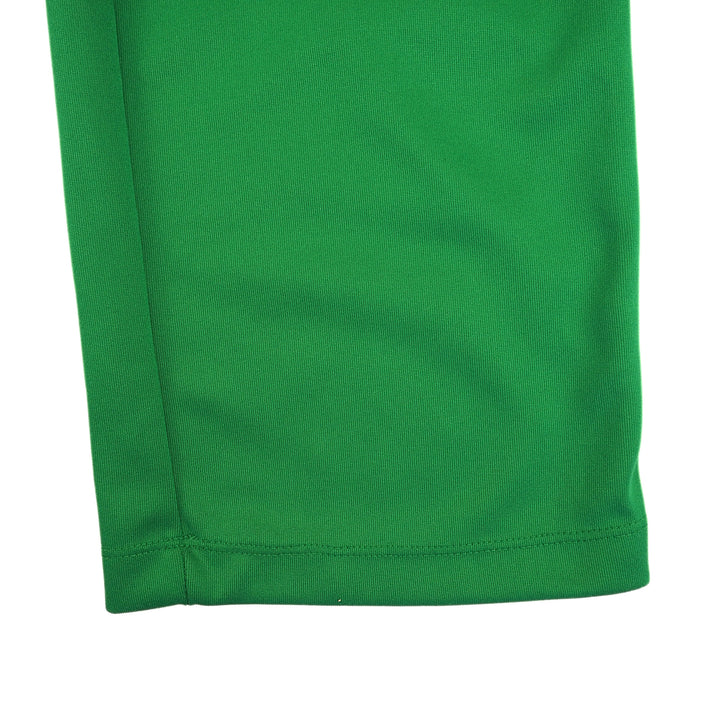 Close-up of green pant leg on a white background