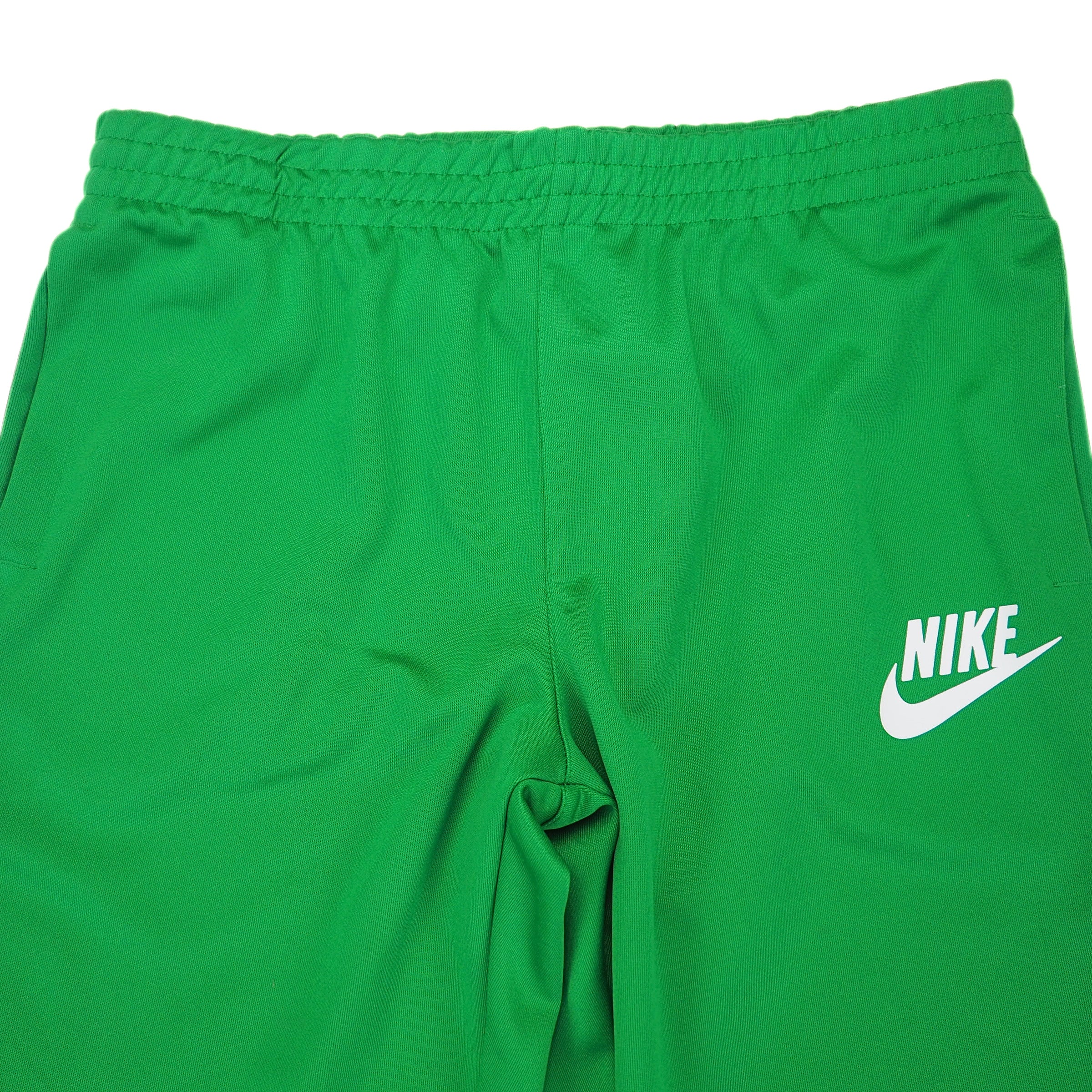 Green tack pants with Nike logo on a white background