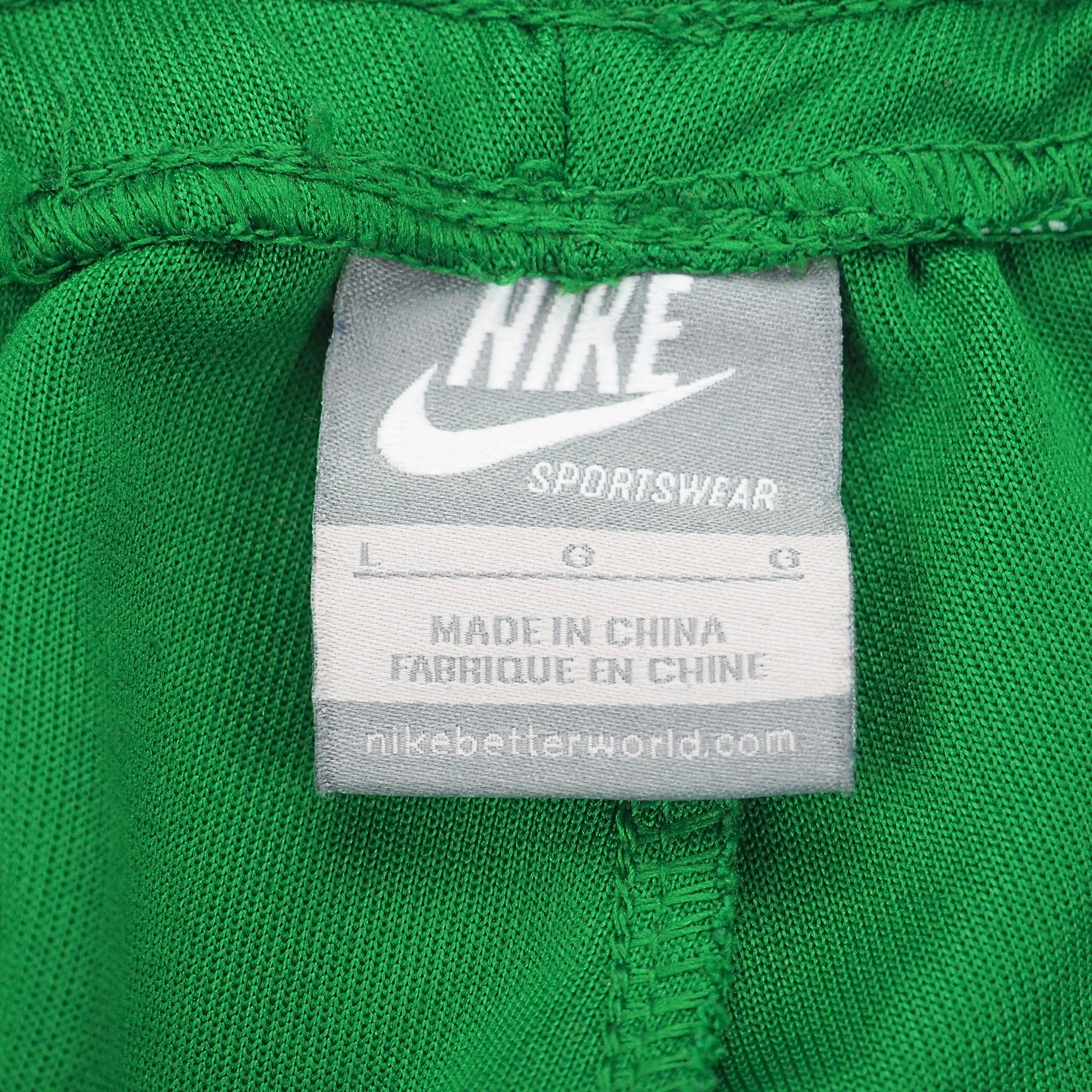 Vintage Y2K Nike Sportswear silver tag on inside of green track pants