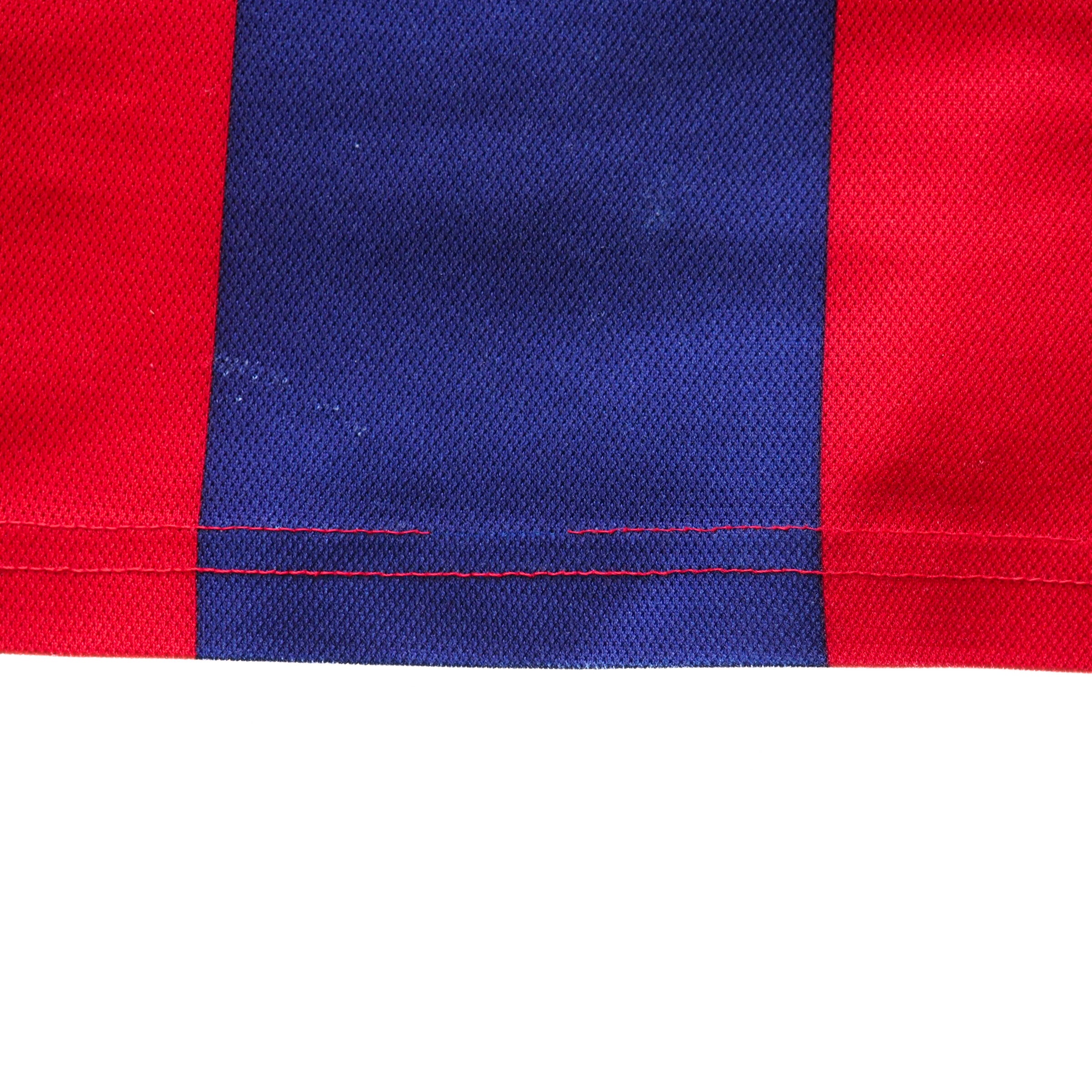 Red and blue striped fabric with a visible seam on a white background