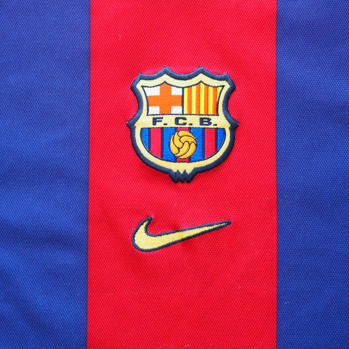 Close-up of a red and blue soccer jersey with a FCB logo and Nike swoosh.